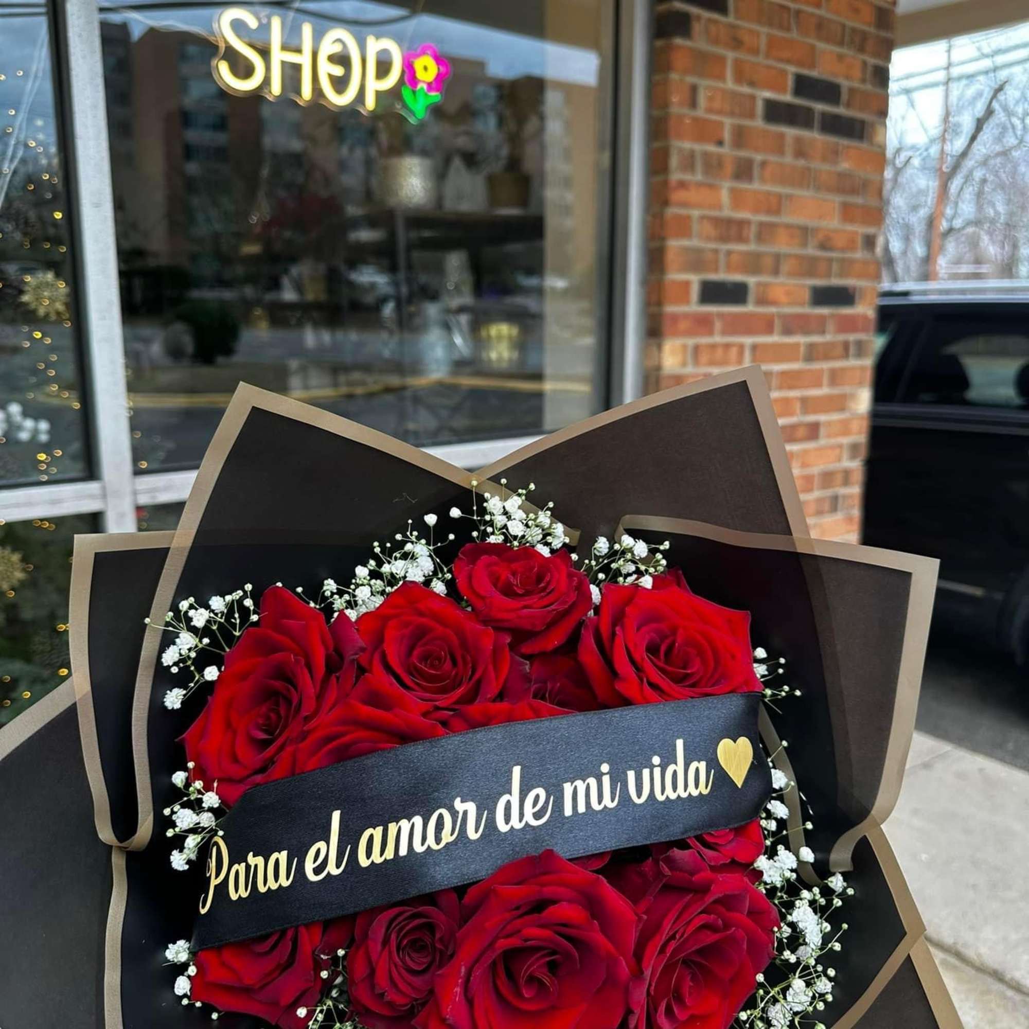 Bouquet of red roses with baby's breath and a ribbon banner