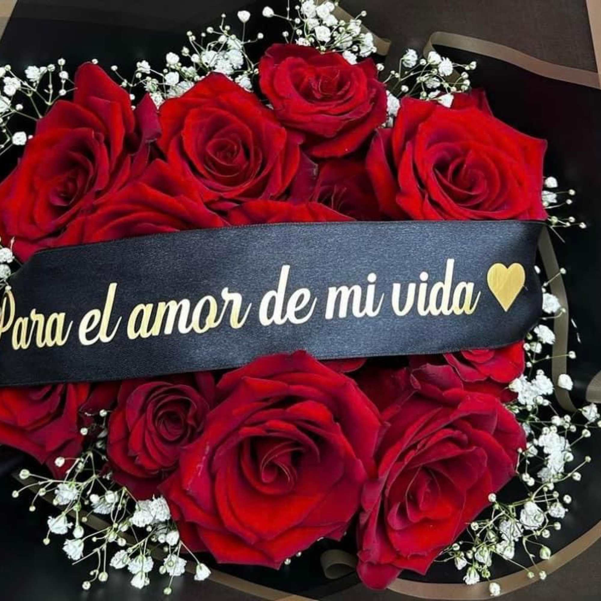 Bouquet of red roses with baby's breath and a black ribbon band
