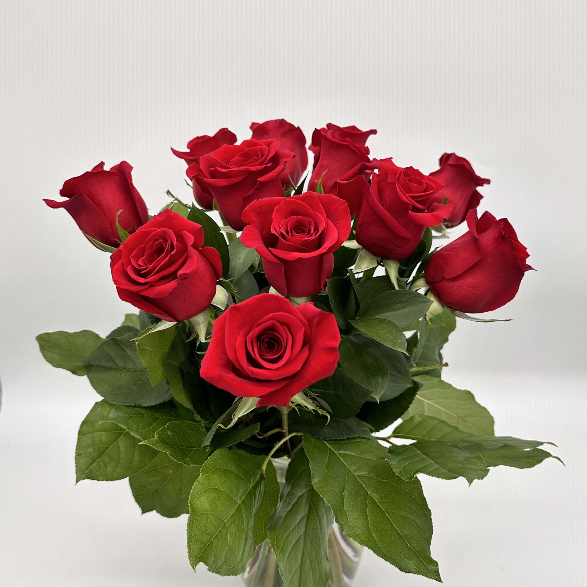Bouquet of red roses in a clear glass vase