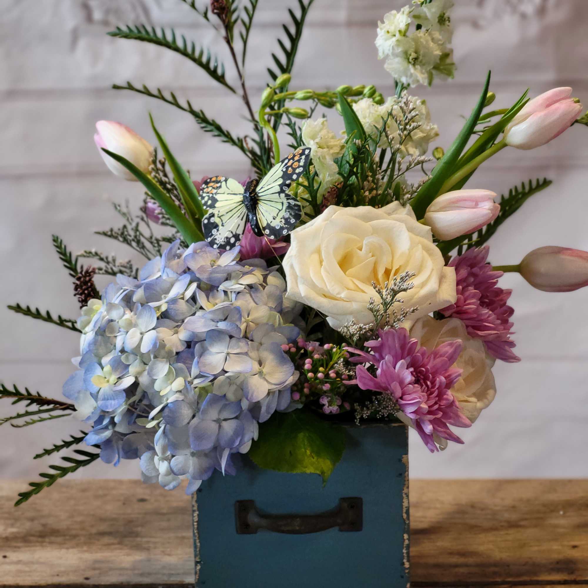 Mixed bouquet with hydrangea, roses, tulips, and chrysanthemums in a blue box