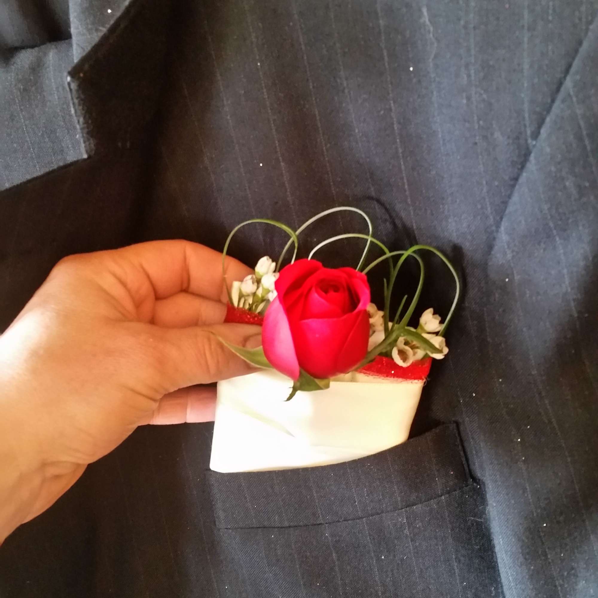 Small red rose boutonniere with white accents