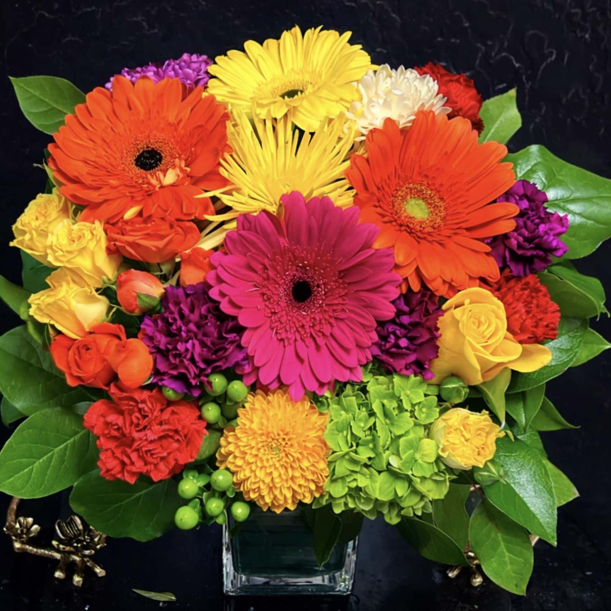 Colorful mixed bouquet in a clear square vase