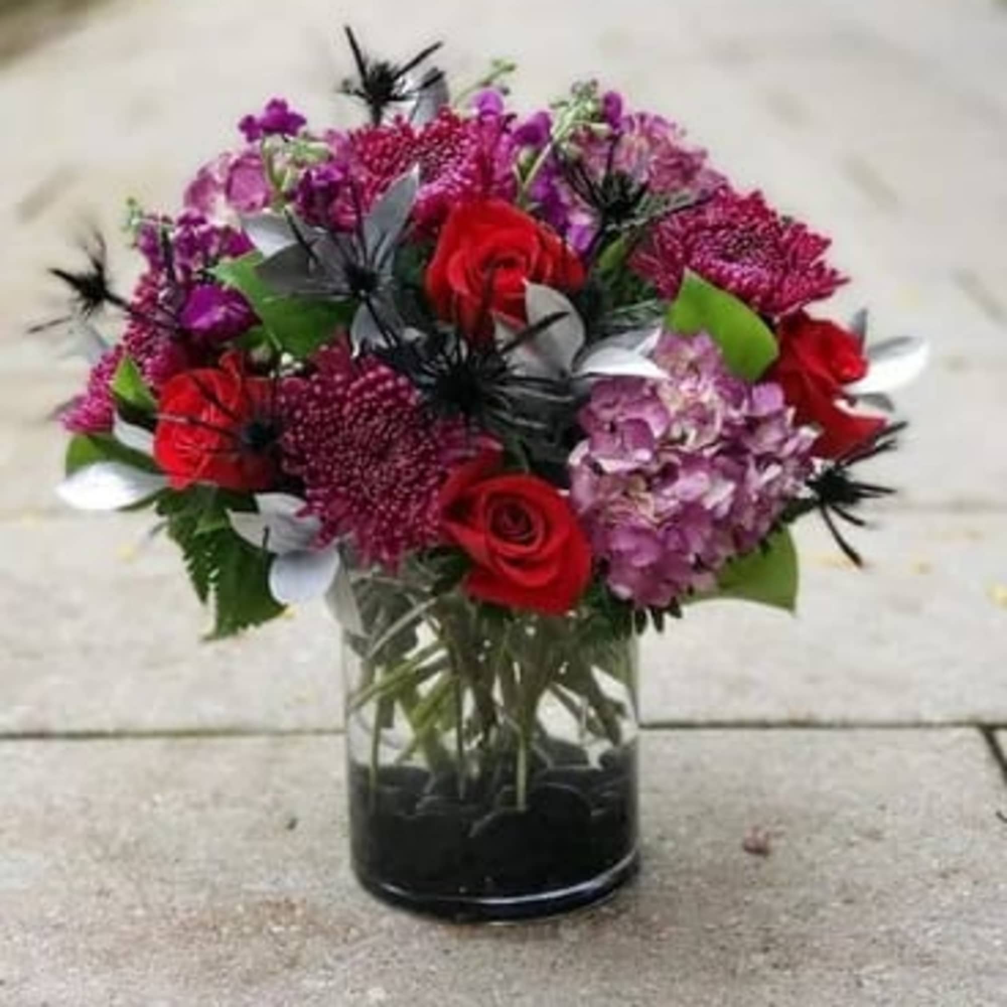 Bouquet of red and purple flowers in a glass vase