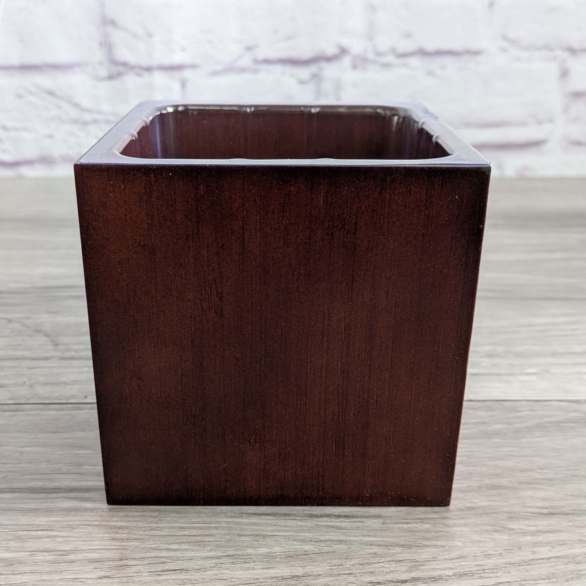 Square dark wood planter with an empty opening