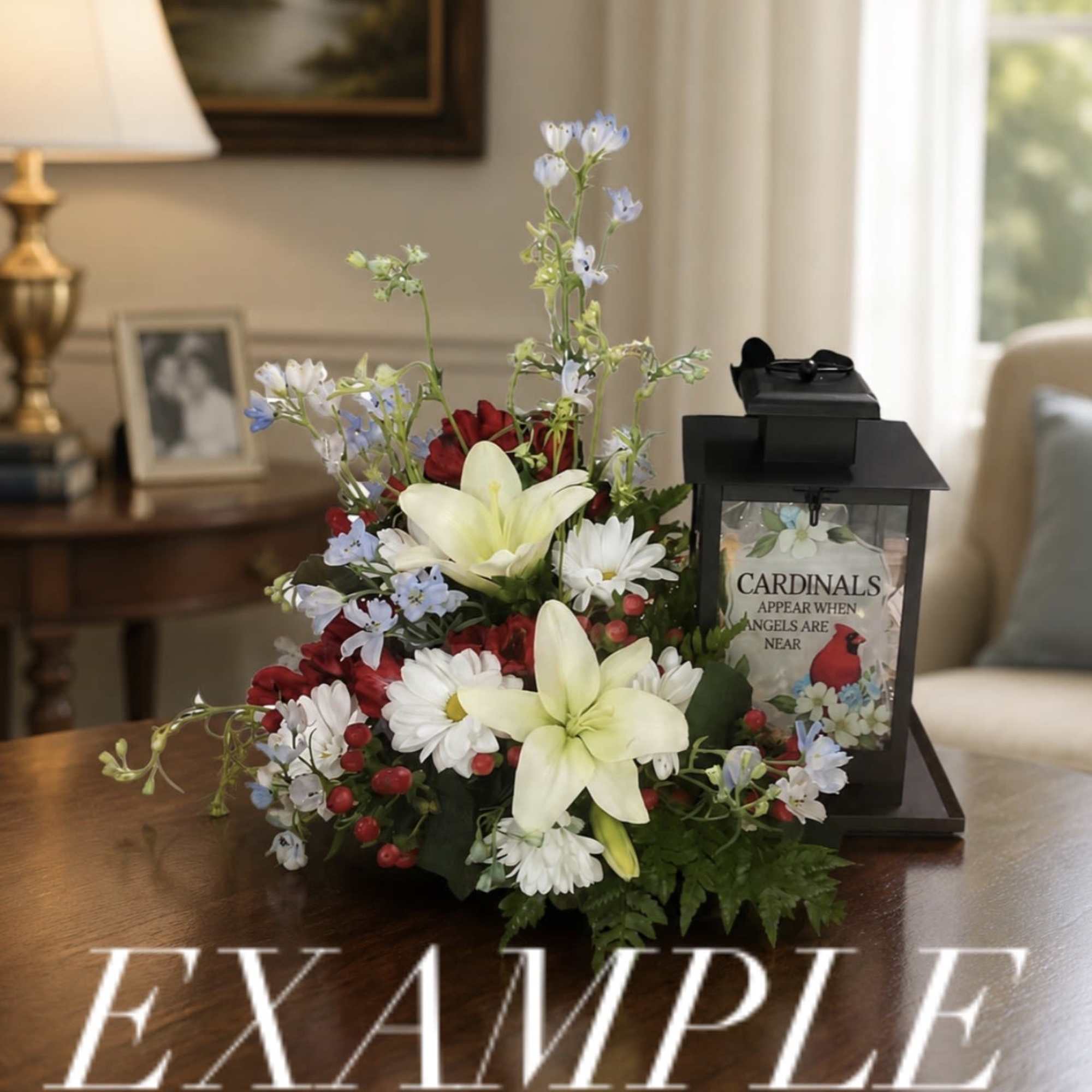 Mixed floral arrangement with lilies, daisies, and a black lantern