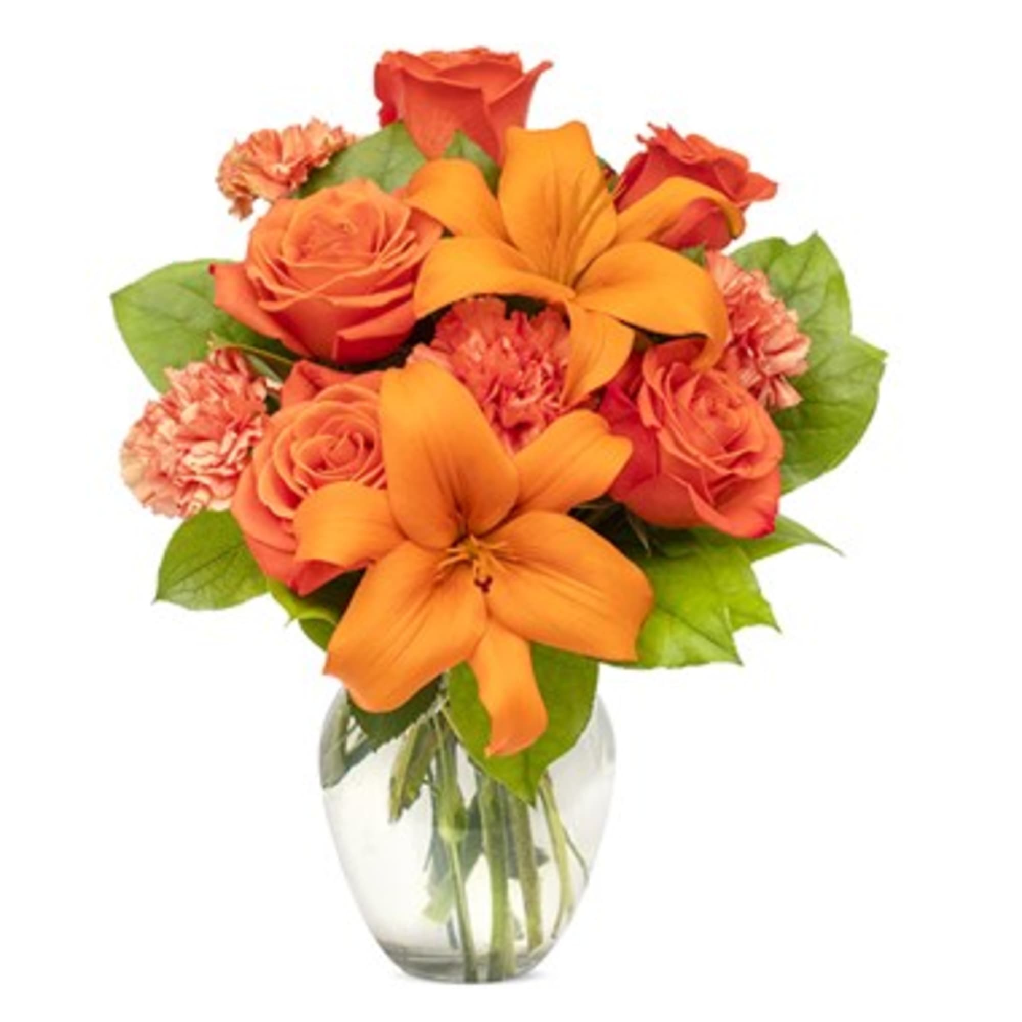 Orange roses and lilies in a clear glass vase