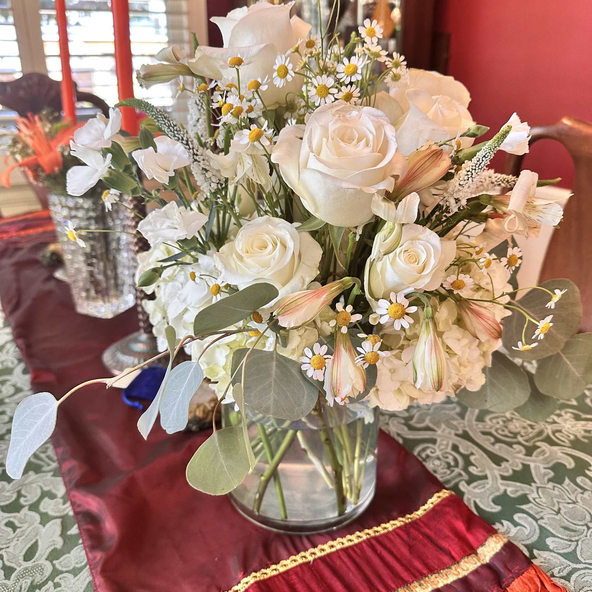 White rose bouquet in a clear glass vase