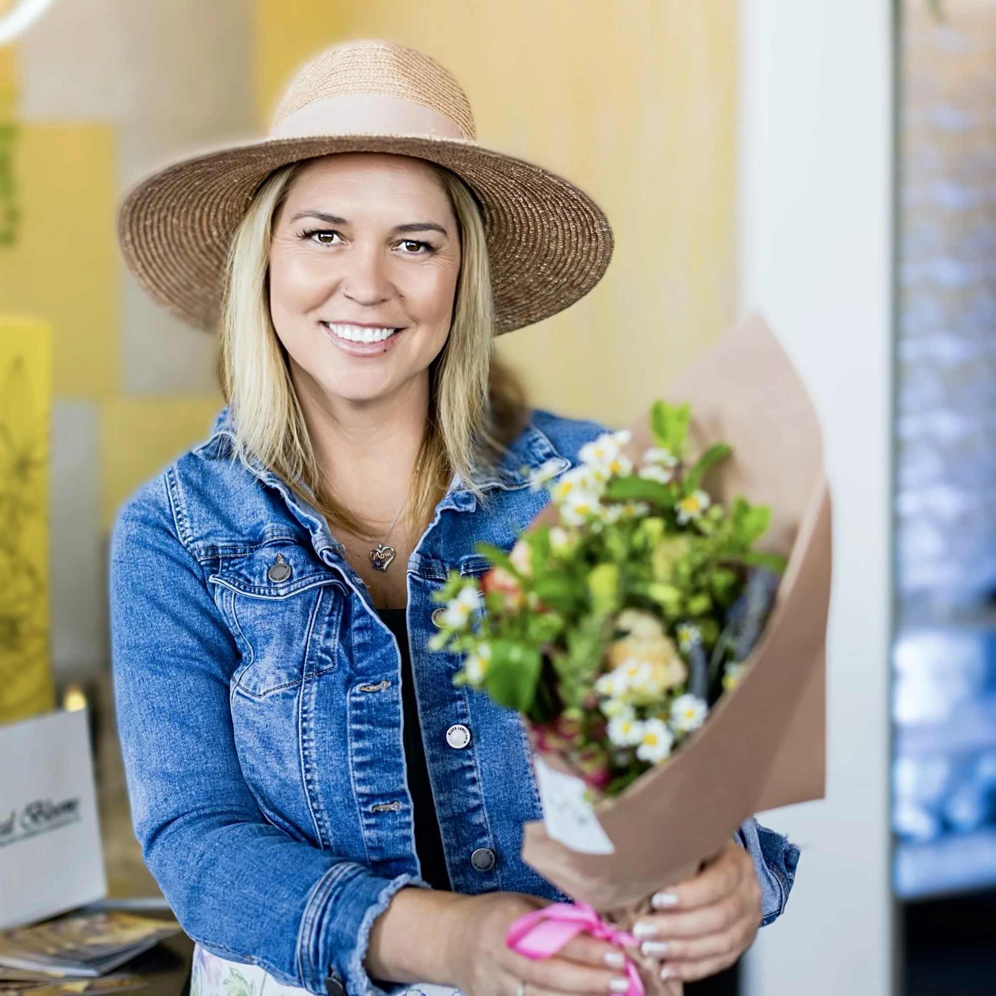 Woman holding a small bouquet wrapped in brown paper