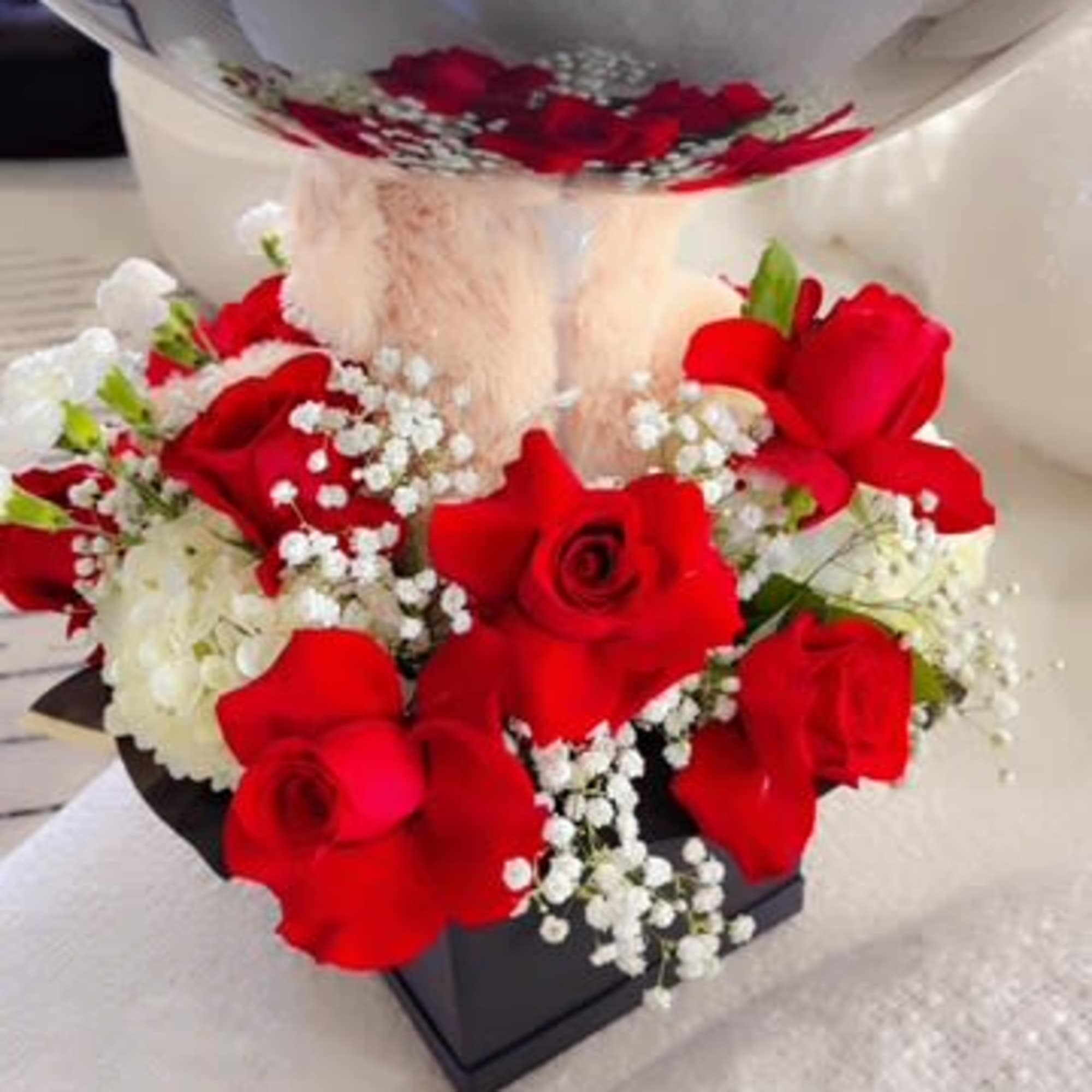 Red roses and white baby's breath in a black box