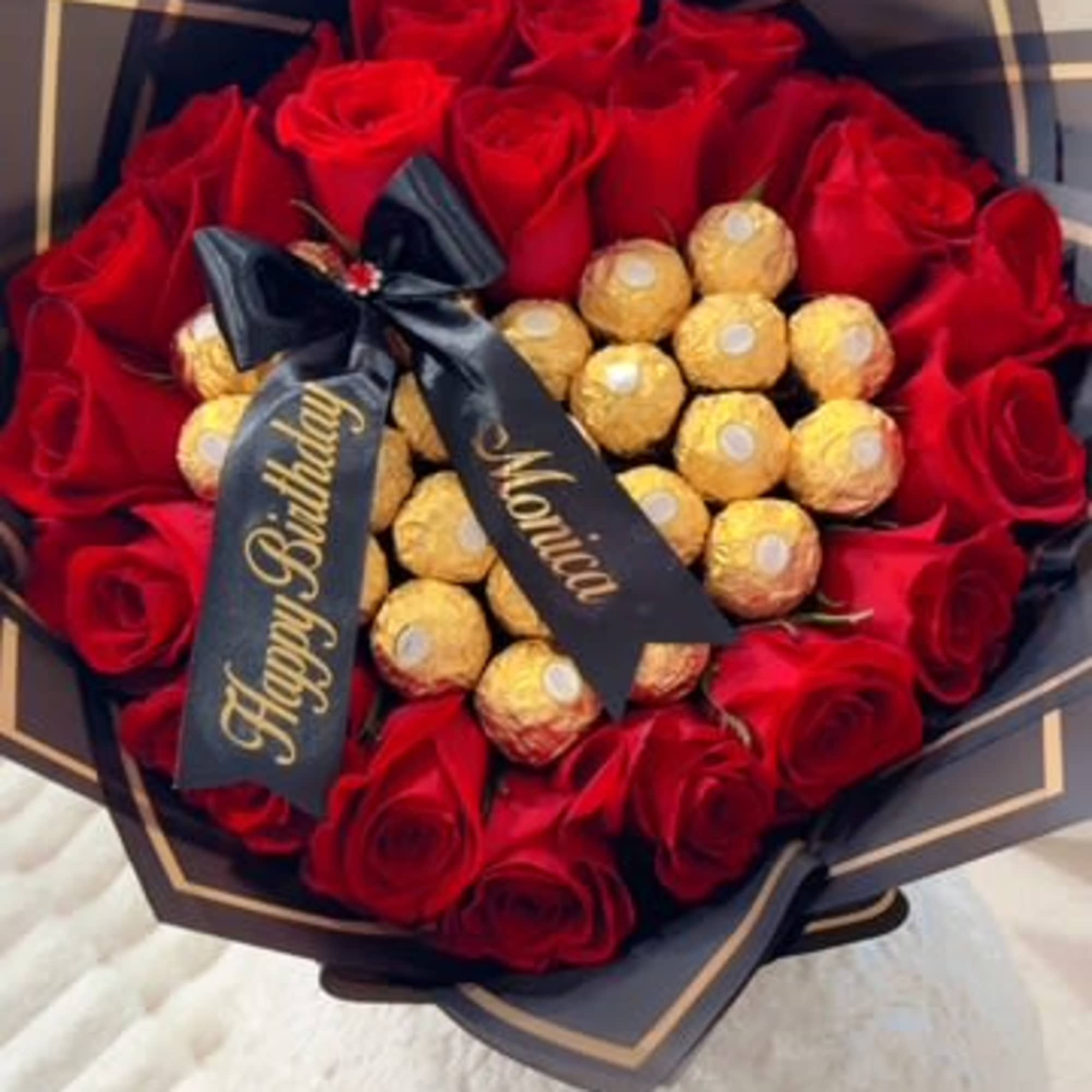 Red rose bouquet with gold chocolates and a birthday ribbon