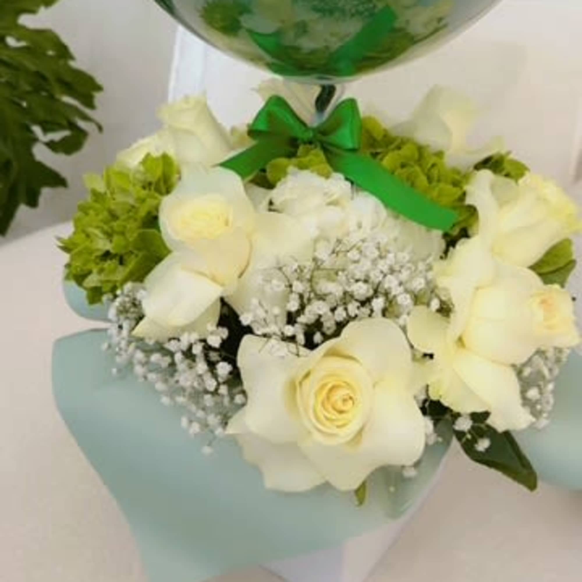 White rose bouquet with baby’s breath and a green balloon