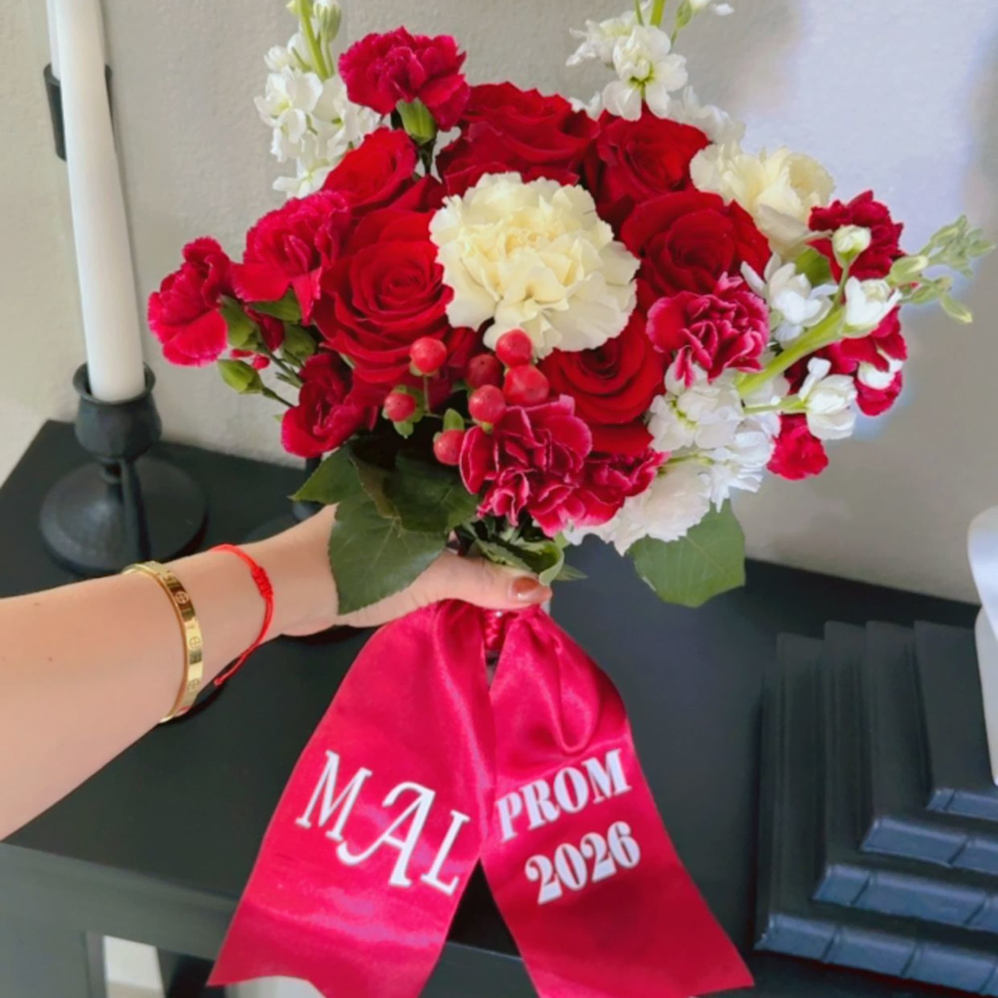 A classic arrangement of rich red roses with soft white accents for