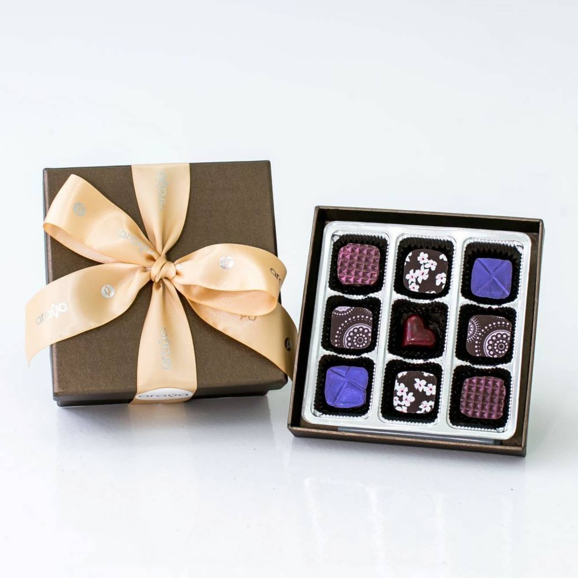 Box of assorted chocolates with a ribbon-tied lid