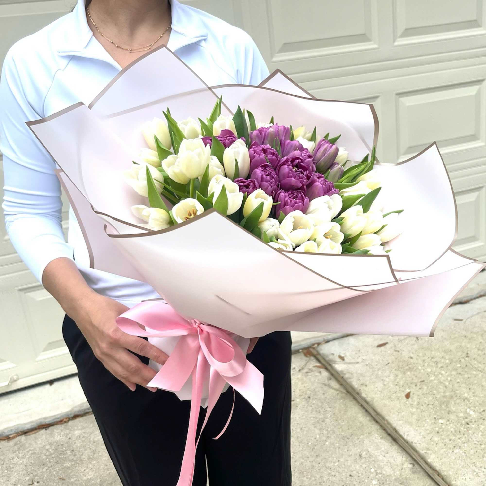 Bouquet of white and purple tulips wrapped in pale pink paper, photo 2 of 3