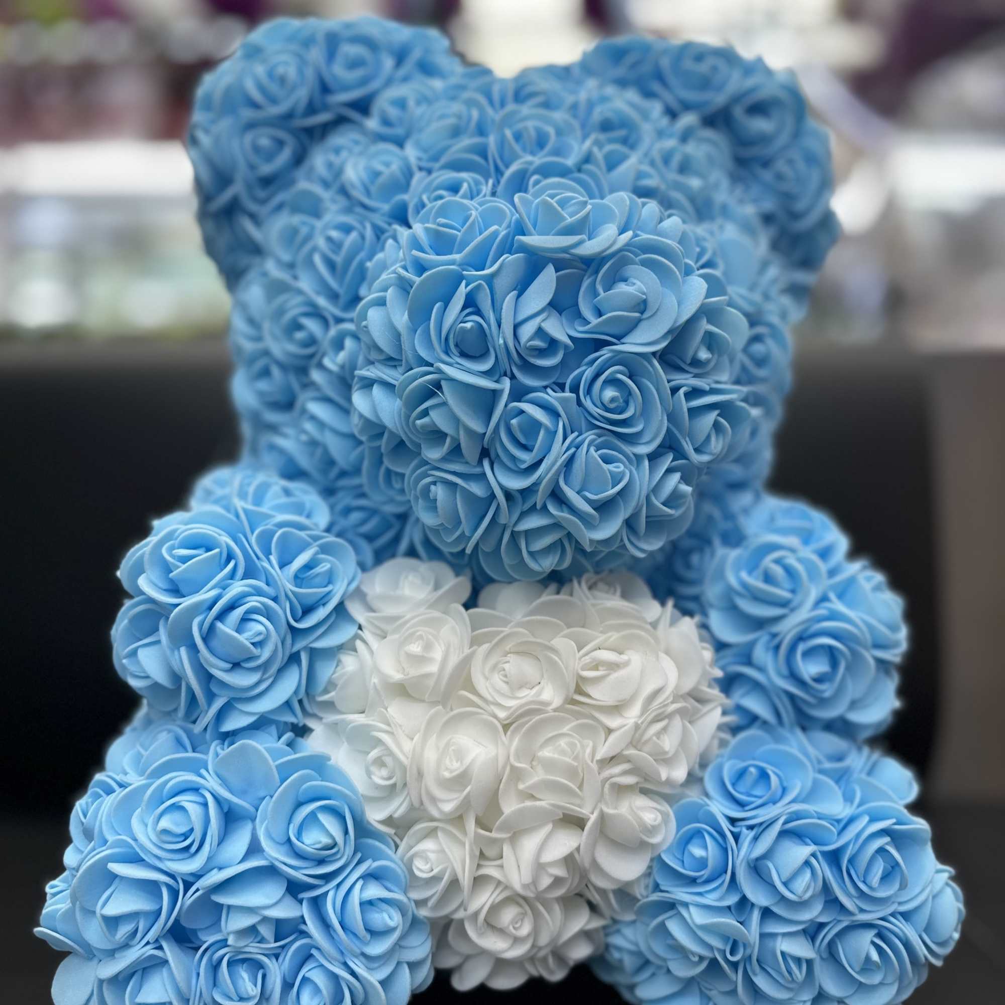 Blue and white teddy bear made of roses