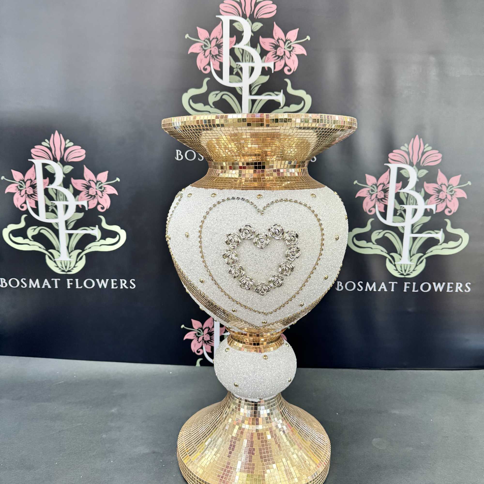 Decorative gold-and-white mosaic pedestal vase with heart embellishments