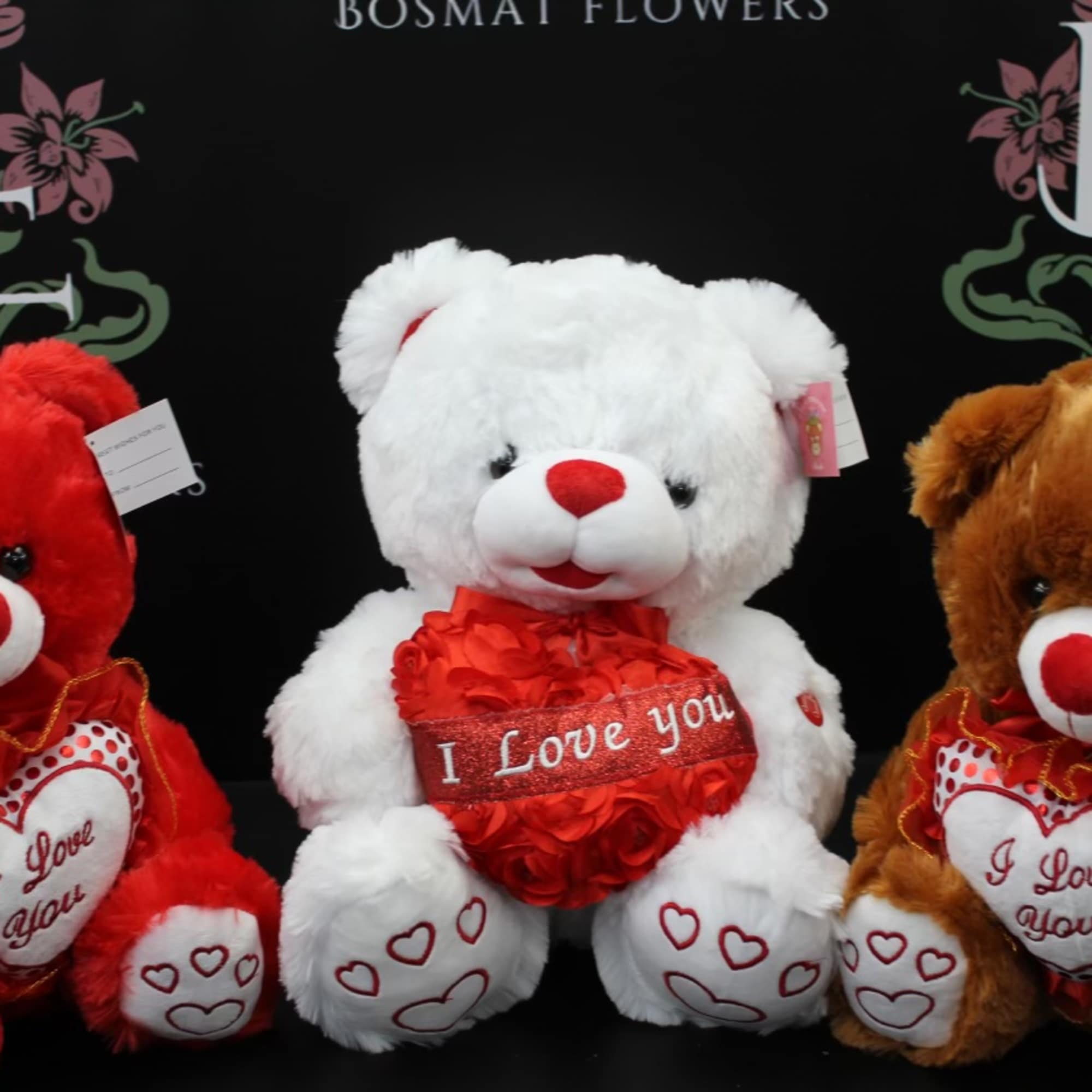 Three teddy bears holding heart decorations and "I Love You" messages