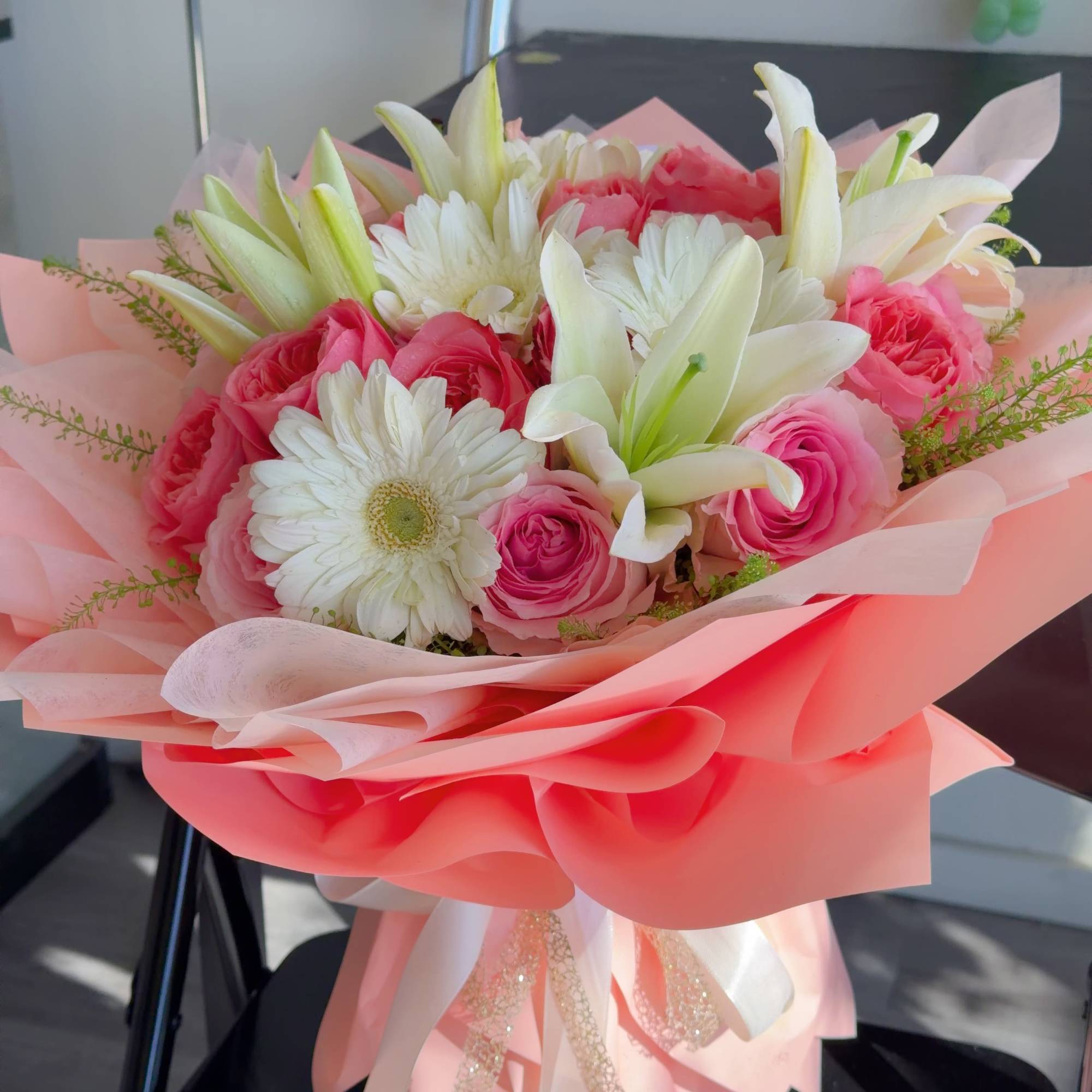 A charming bouquet of soft pink roses, white lilies, and fresh gerbera, photo 3 of 3