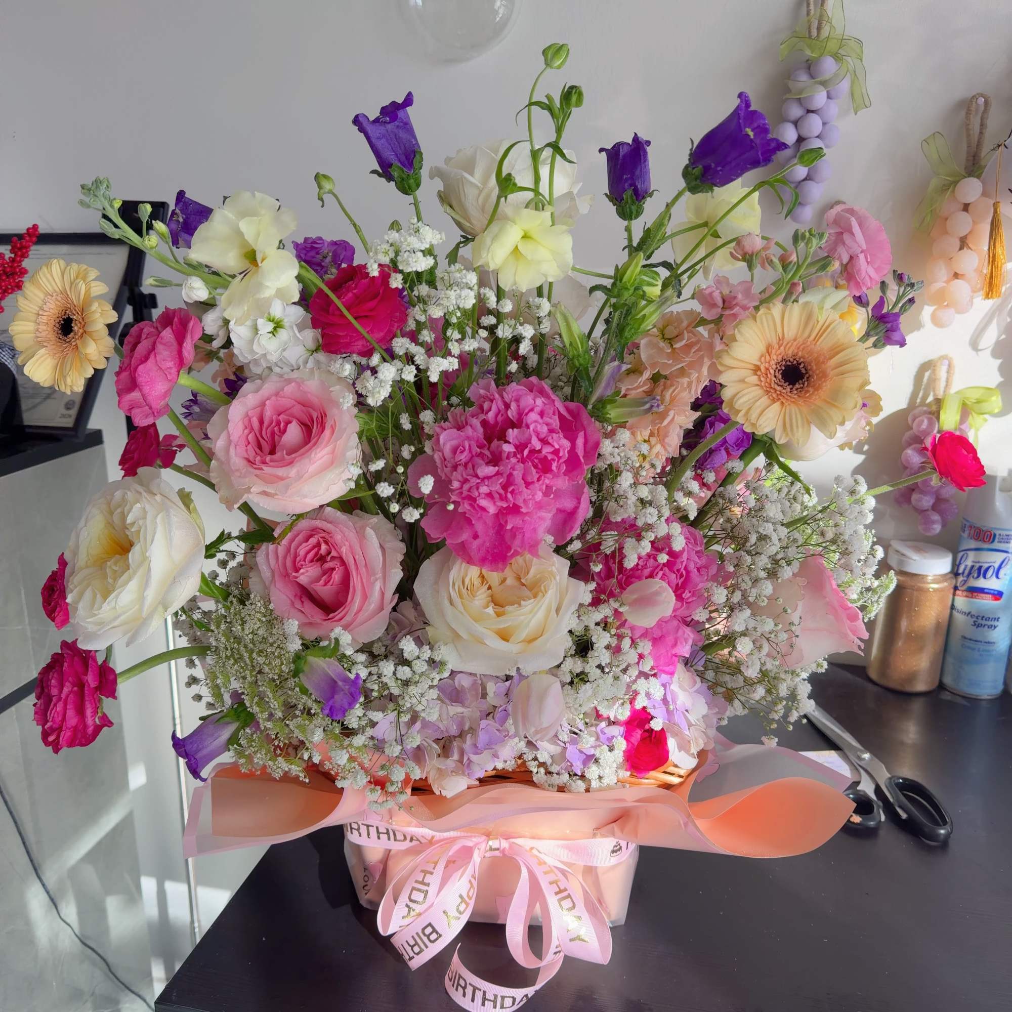 This elegant double-sided floral basket arrangement is designed to be admired from