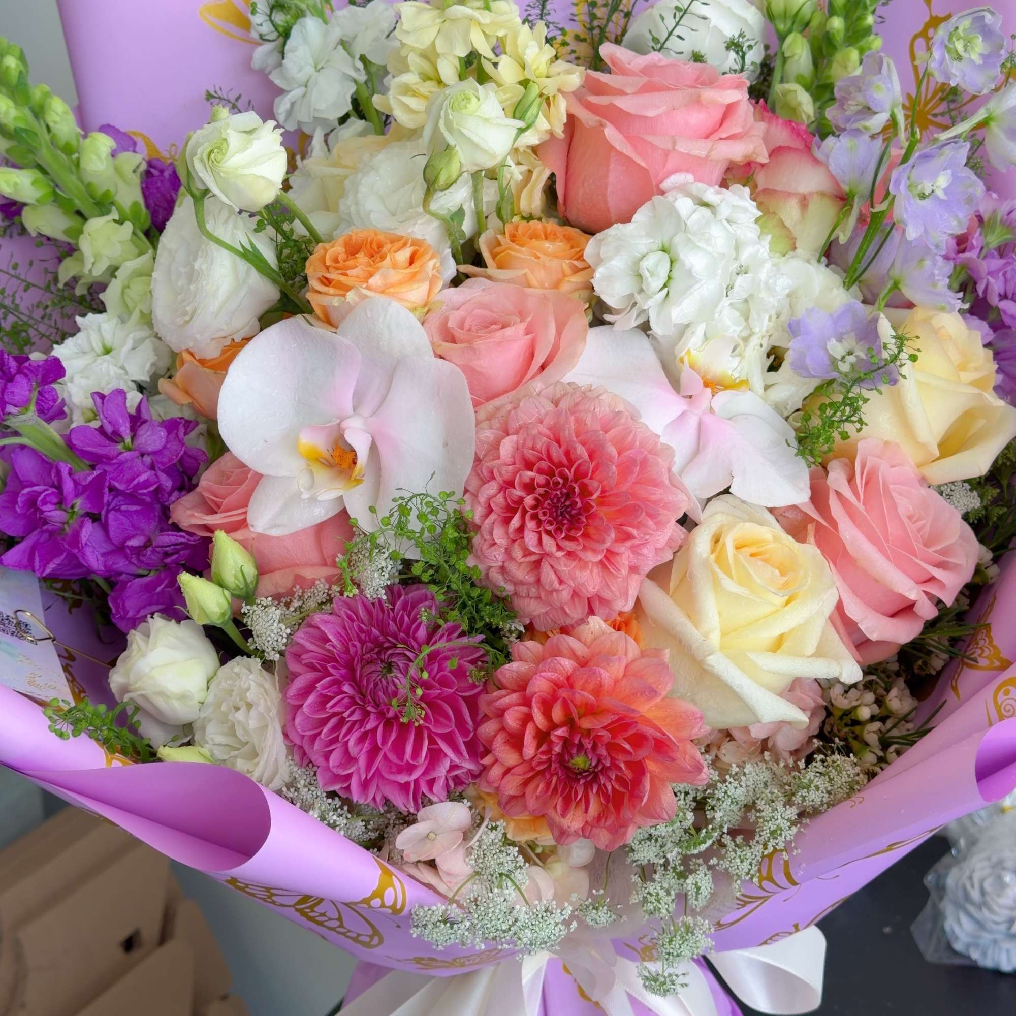 Mixed bouquet of pink, white, and purple flowers wrapped in lavender paper, photo 3 of 5