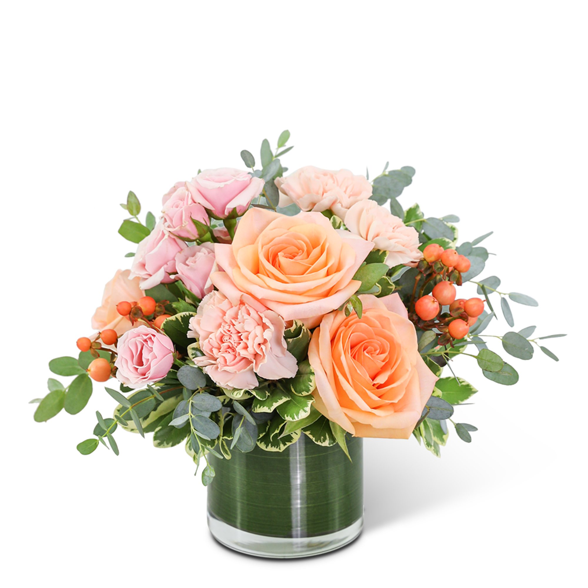 Peach and pink roses with carnations in a glass vase