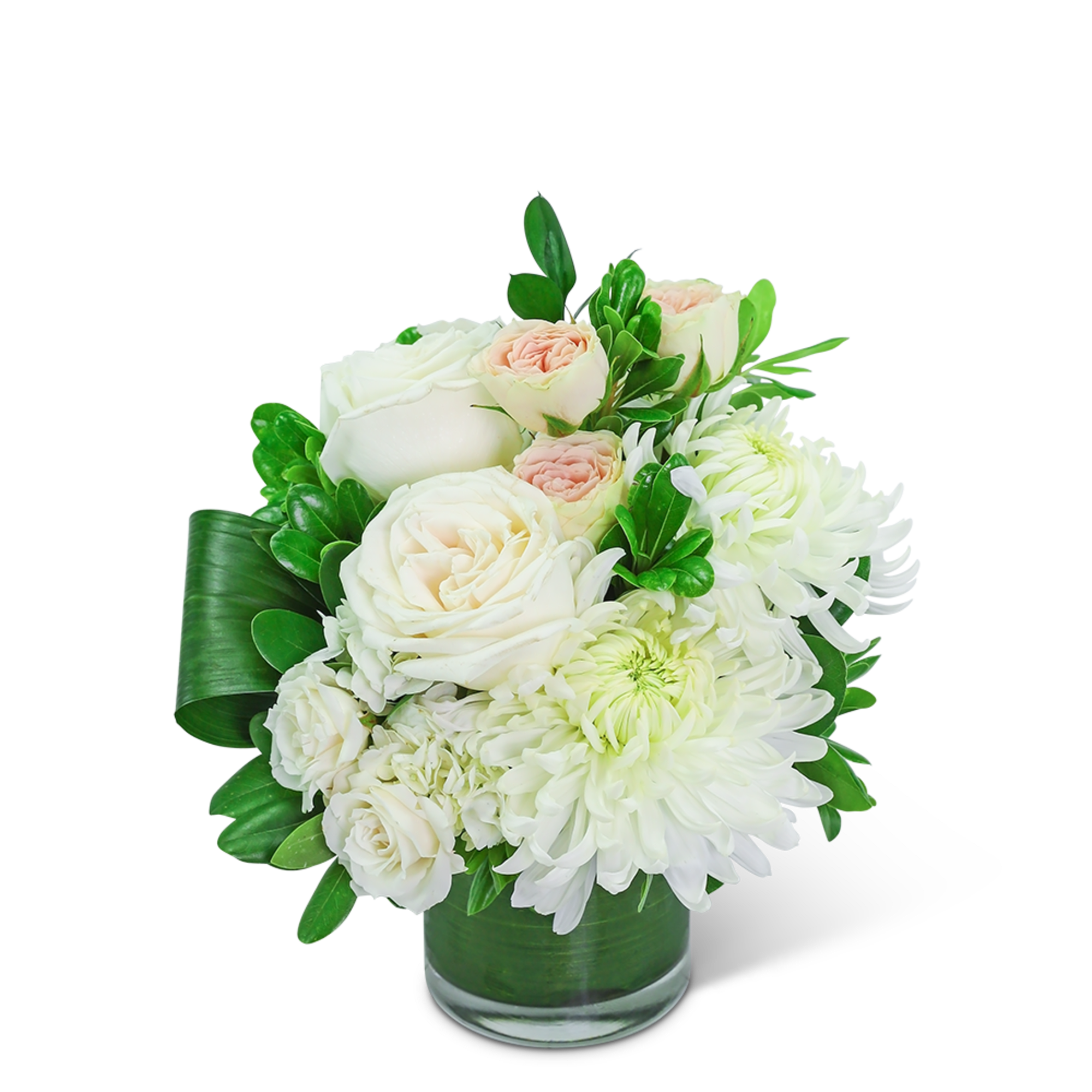 White roses and chrysanthemums in a glass vase with green leaves