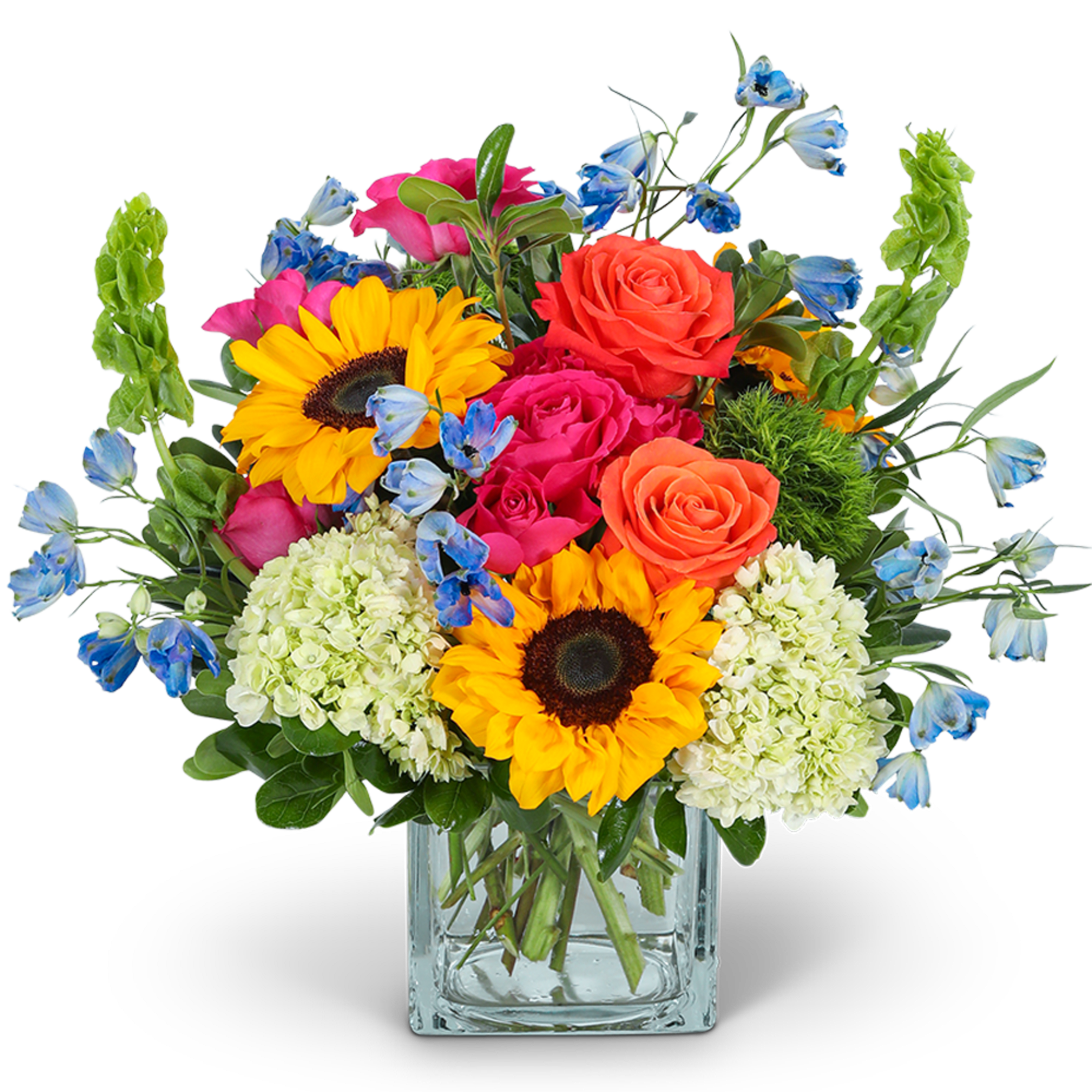 Mixed bouquet with sunflowers, roses, hydrangeas, and blue accent flowers in a glass vase