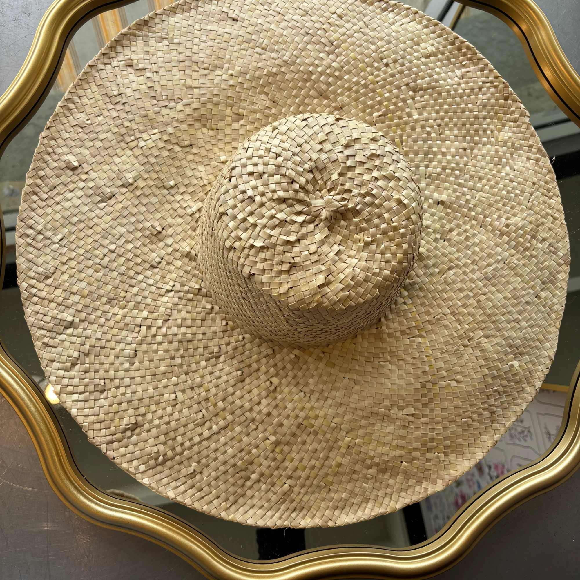 Wide woven straw hat with a rounded crown