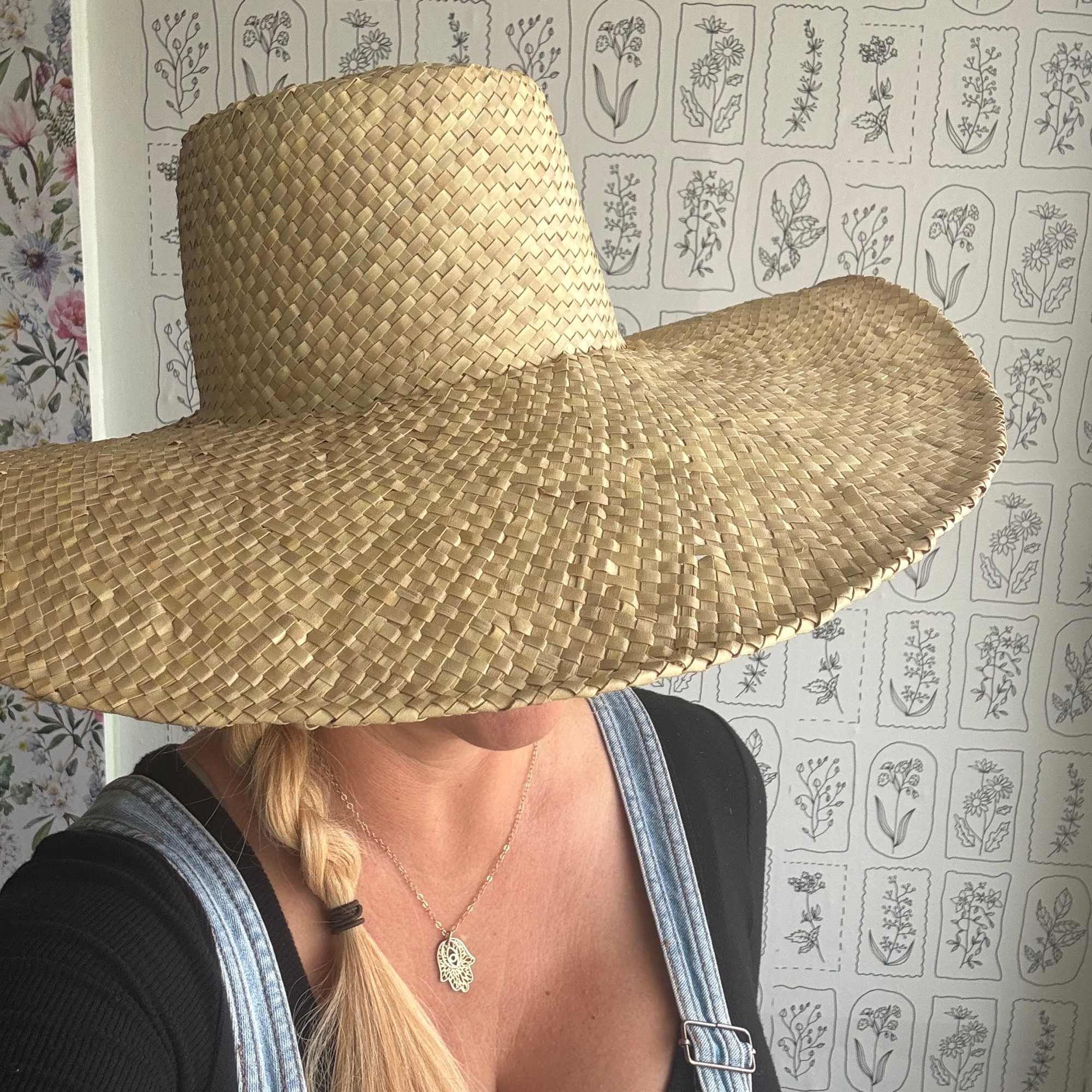 Person wearing a large woven straw hat
