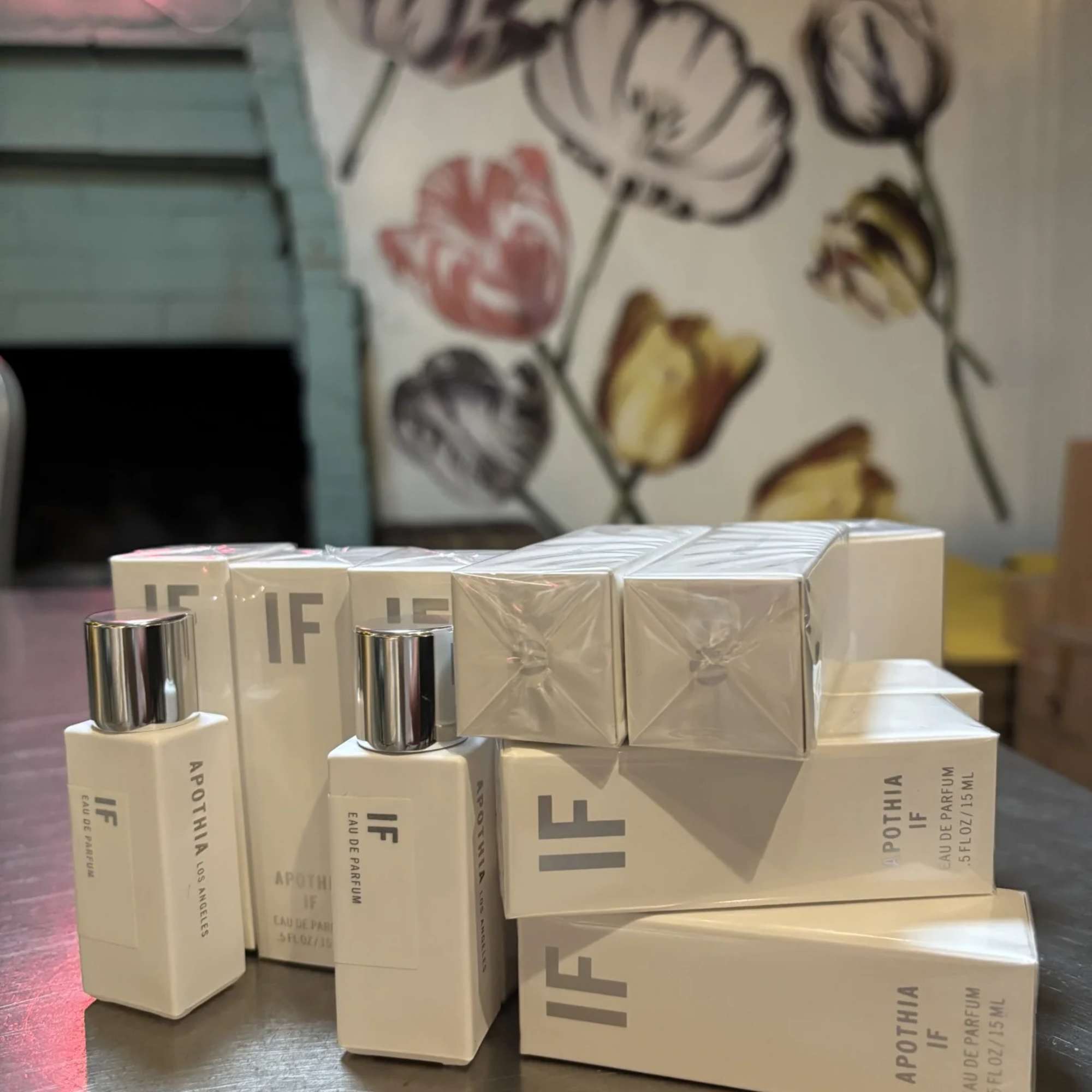 Stacked perfume boxes and bottles on a table