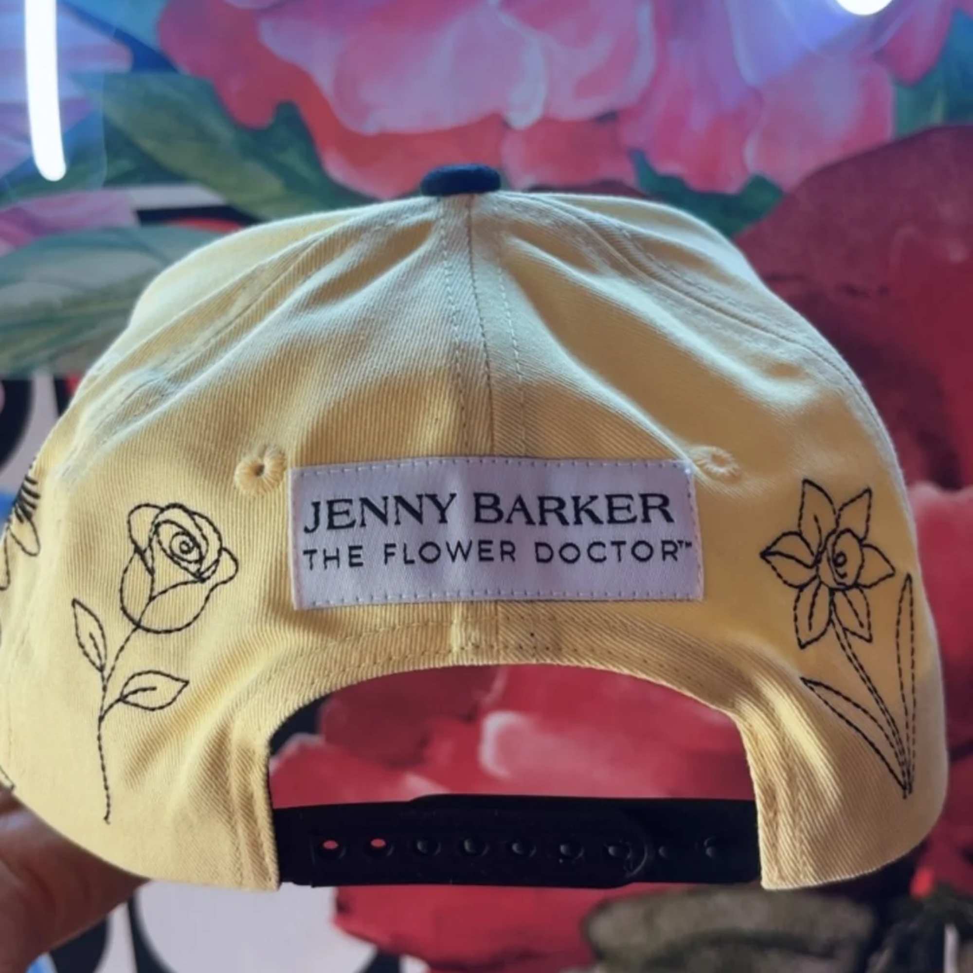 Yellow cap with floral embroidery and a Jenny Barker label