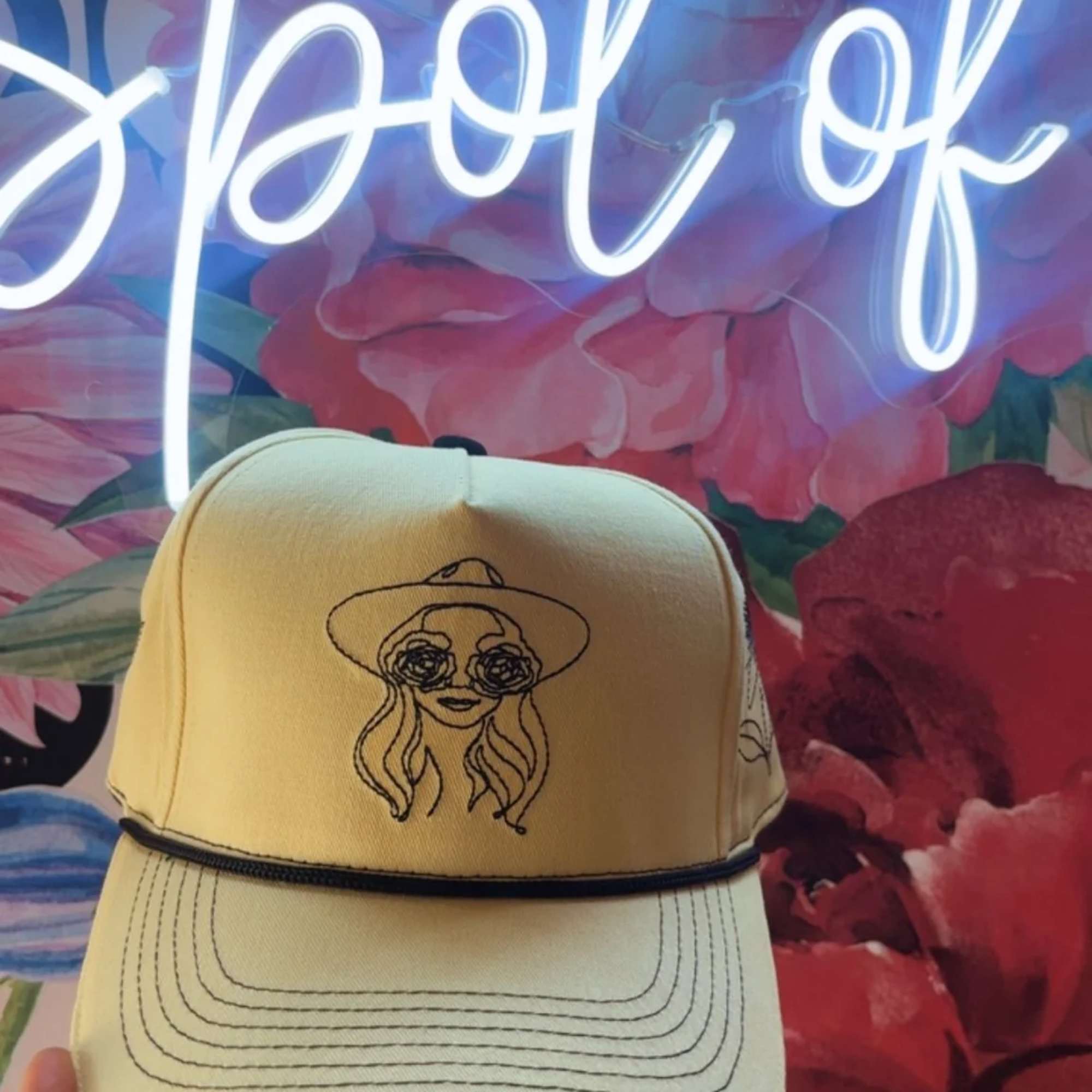 Yellow baseball cap with a line-drawn face graphic
