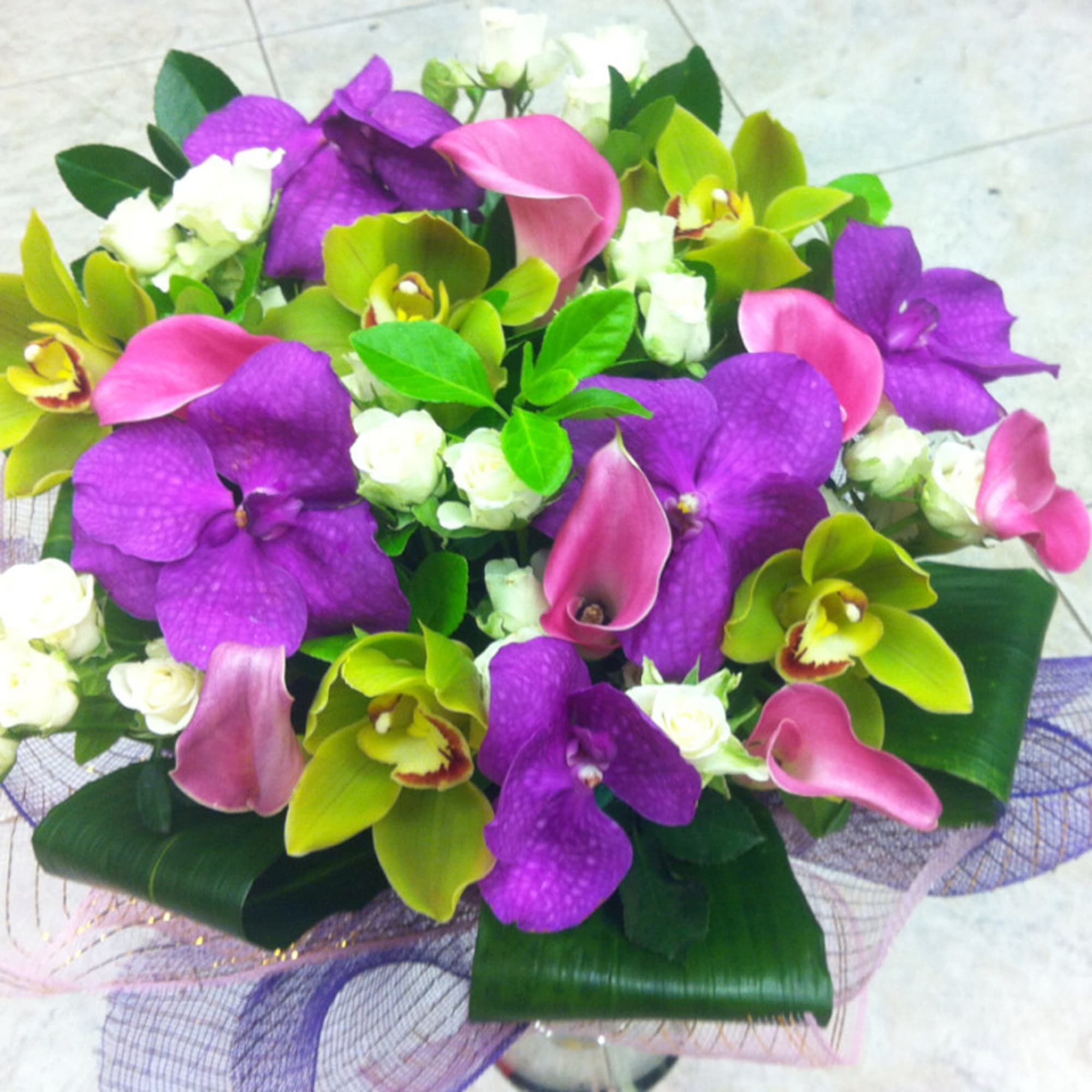 Bouquet of purple orchids, pink calla lilies, and white roses