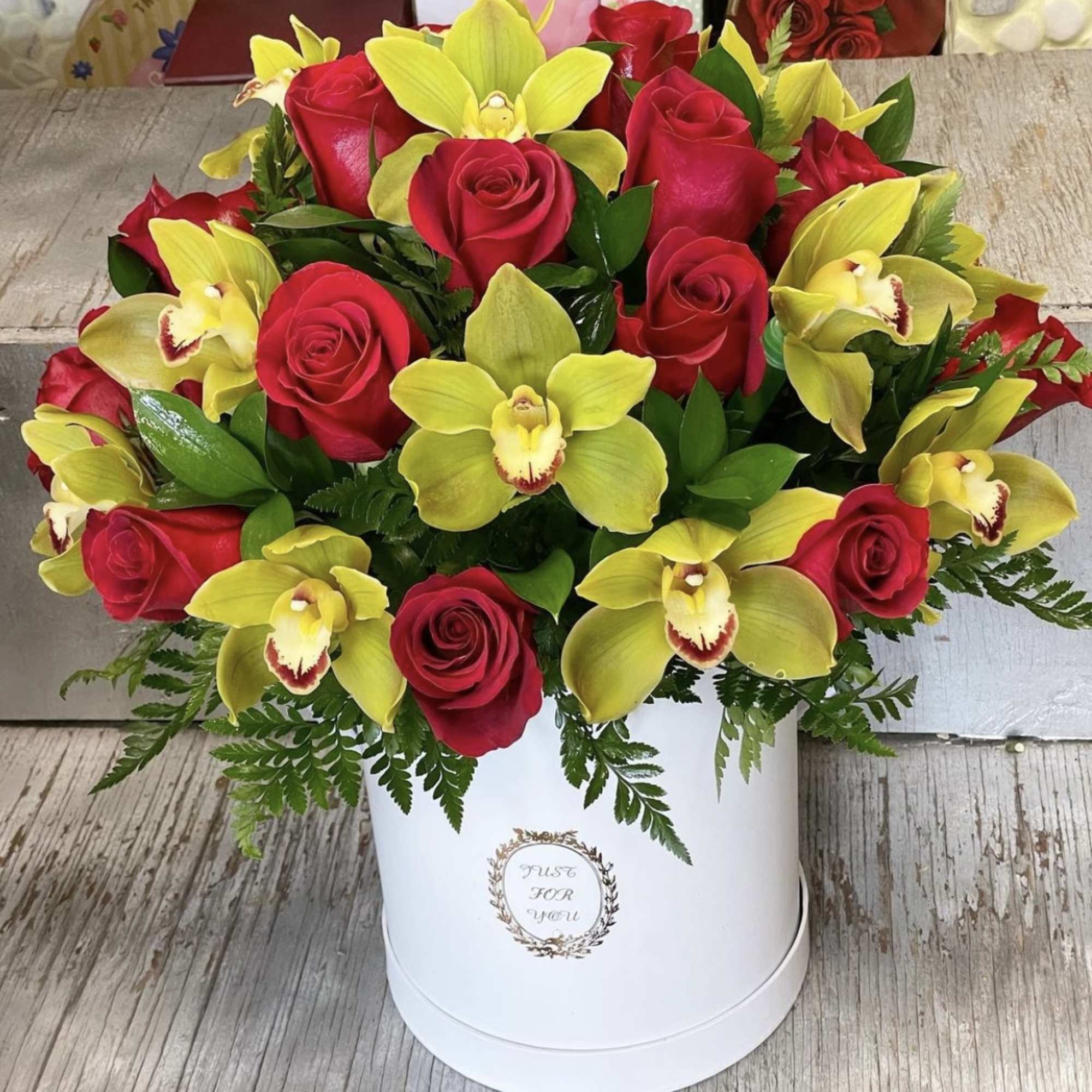 Red roses and yellow orchids arranged in a white hat box, photo 2 of 2