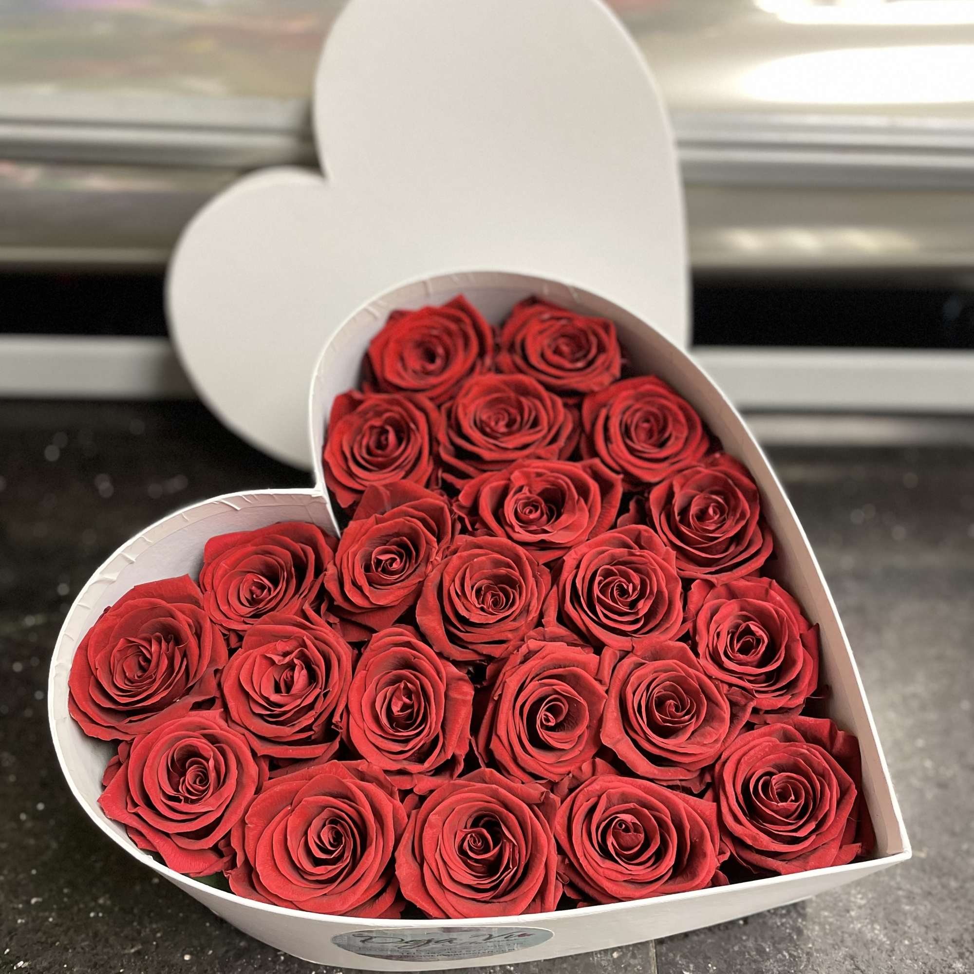 Heart-shaped box filled with red roses