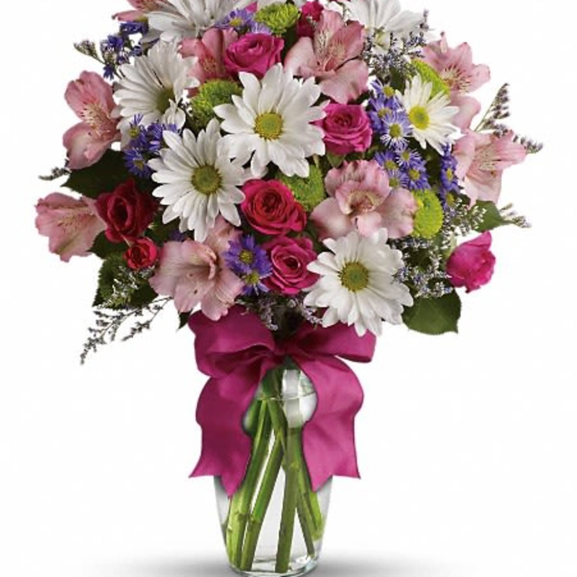 Mixed bouquet of pink roses, white daisies, and alstroemeria in a glass vase