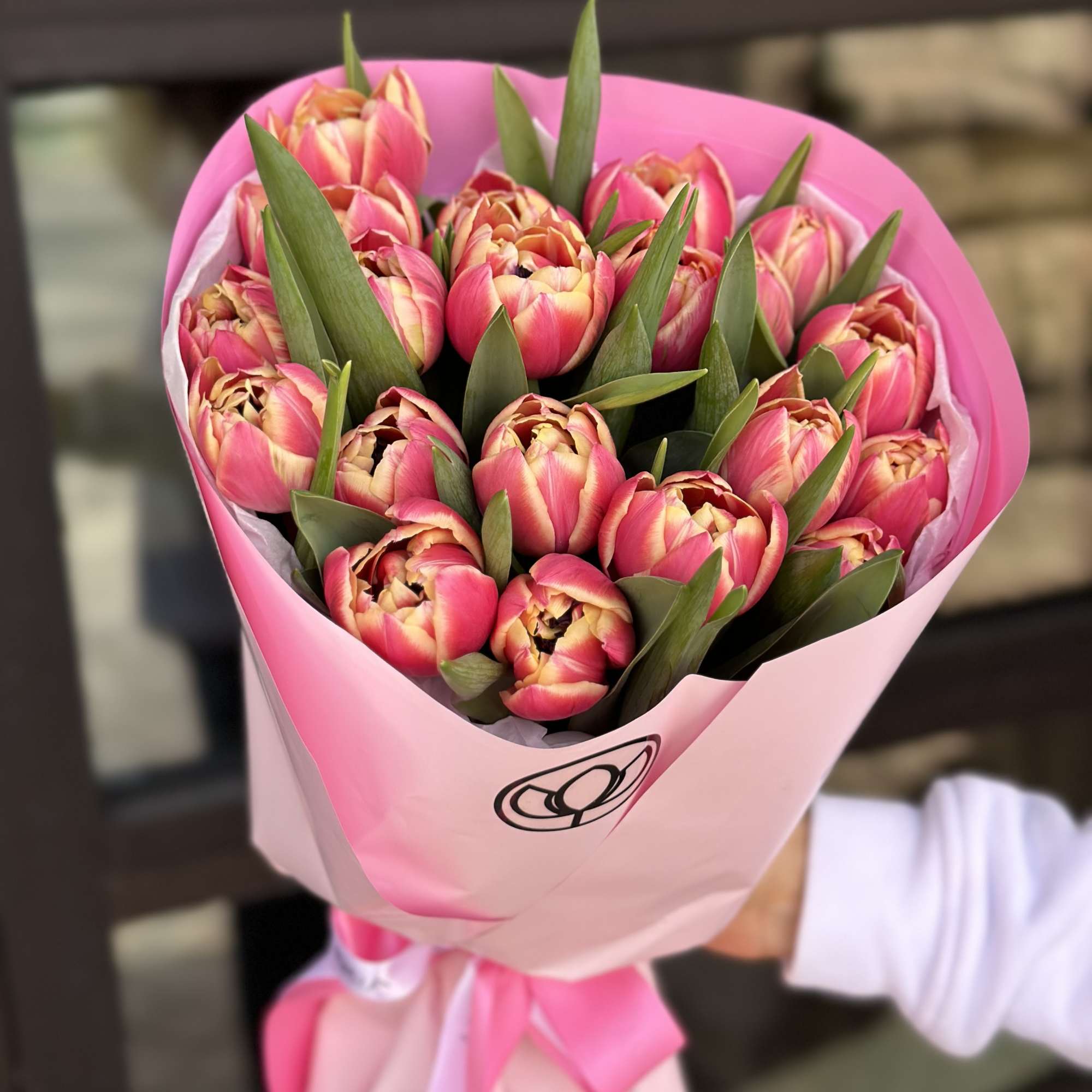 Bouquet of pink tulips wrapped in pink paper with a ribbon, photo 2 of 6