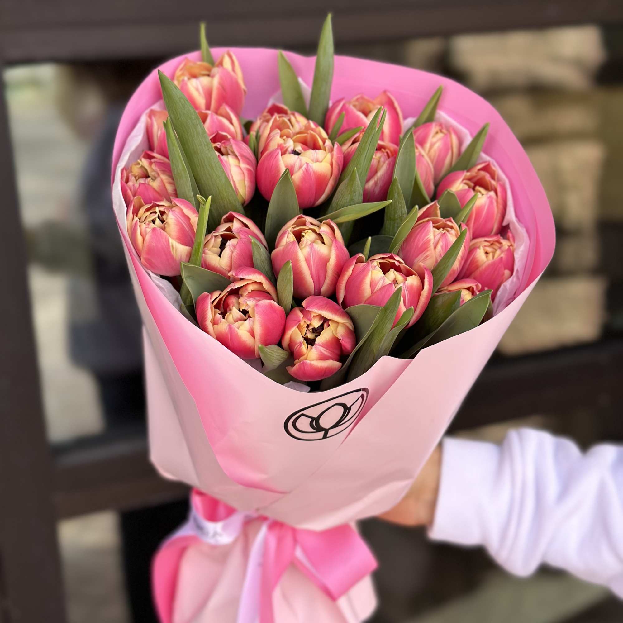 Bouquet of pink tulips wrapped in pink paper
