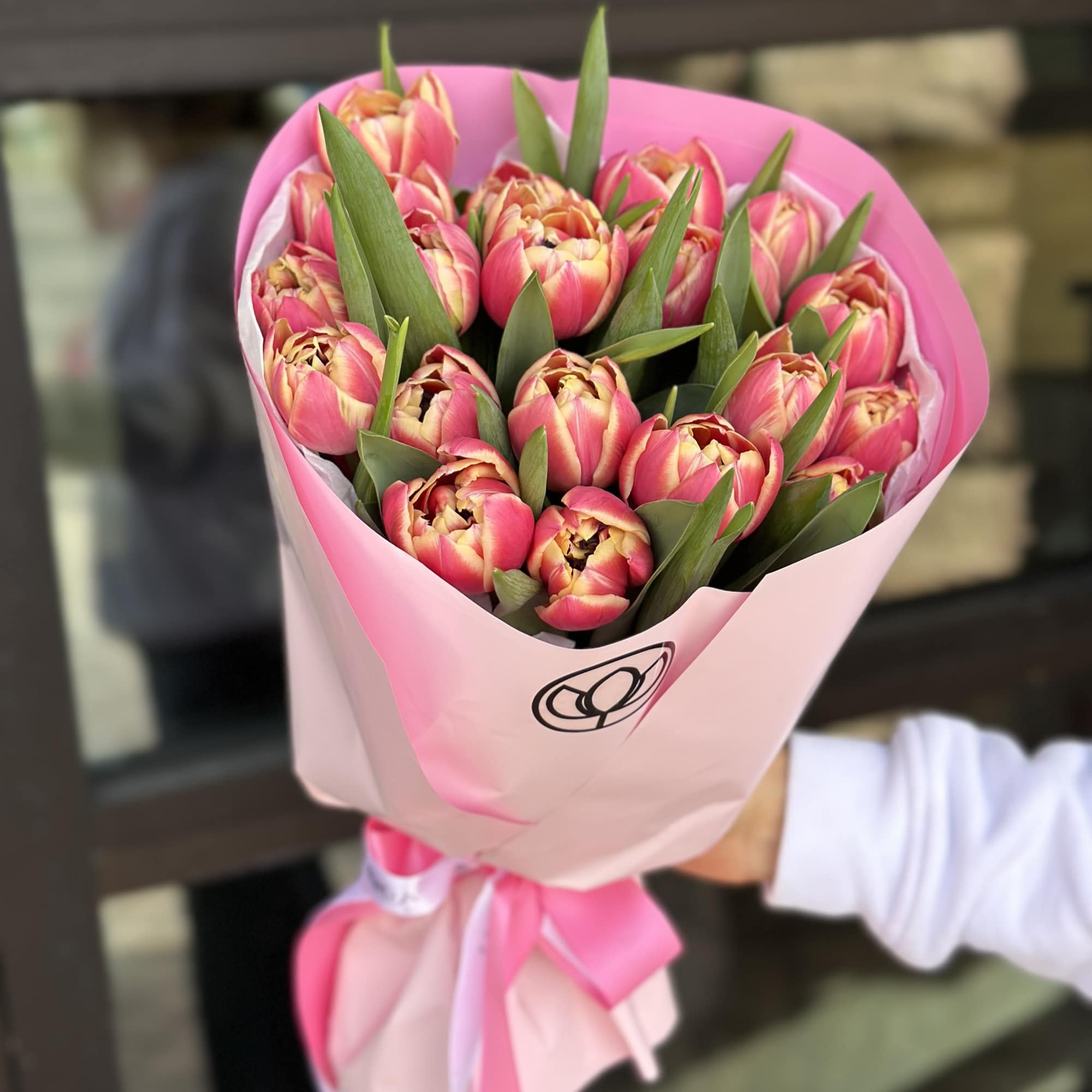 Bouquet of pink tulips wrapped in pink paper with a ribbon, photo 5 of 6