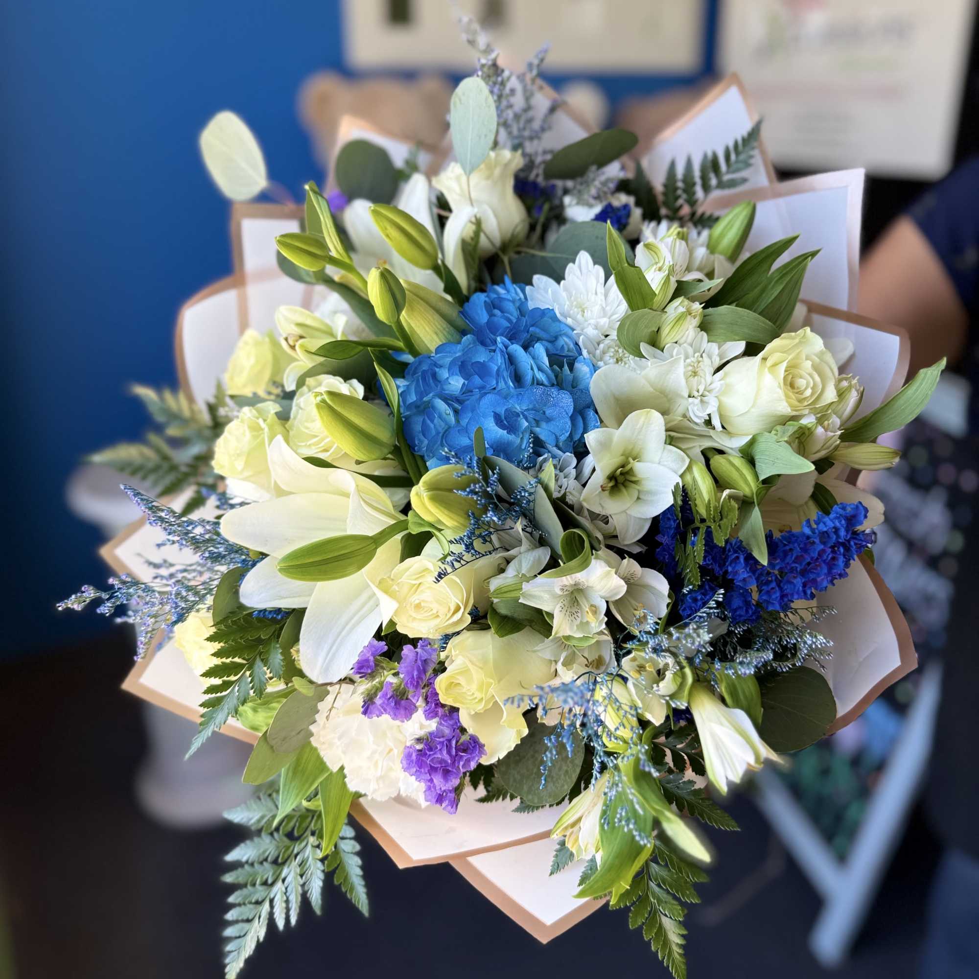 This blue-wrapped bouquet features a 'buchon' style and will include the same