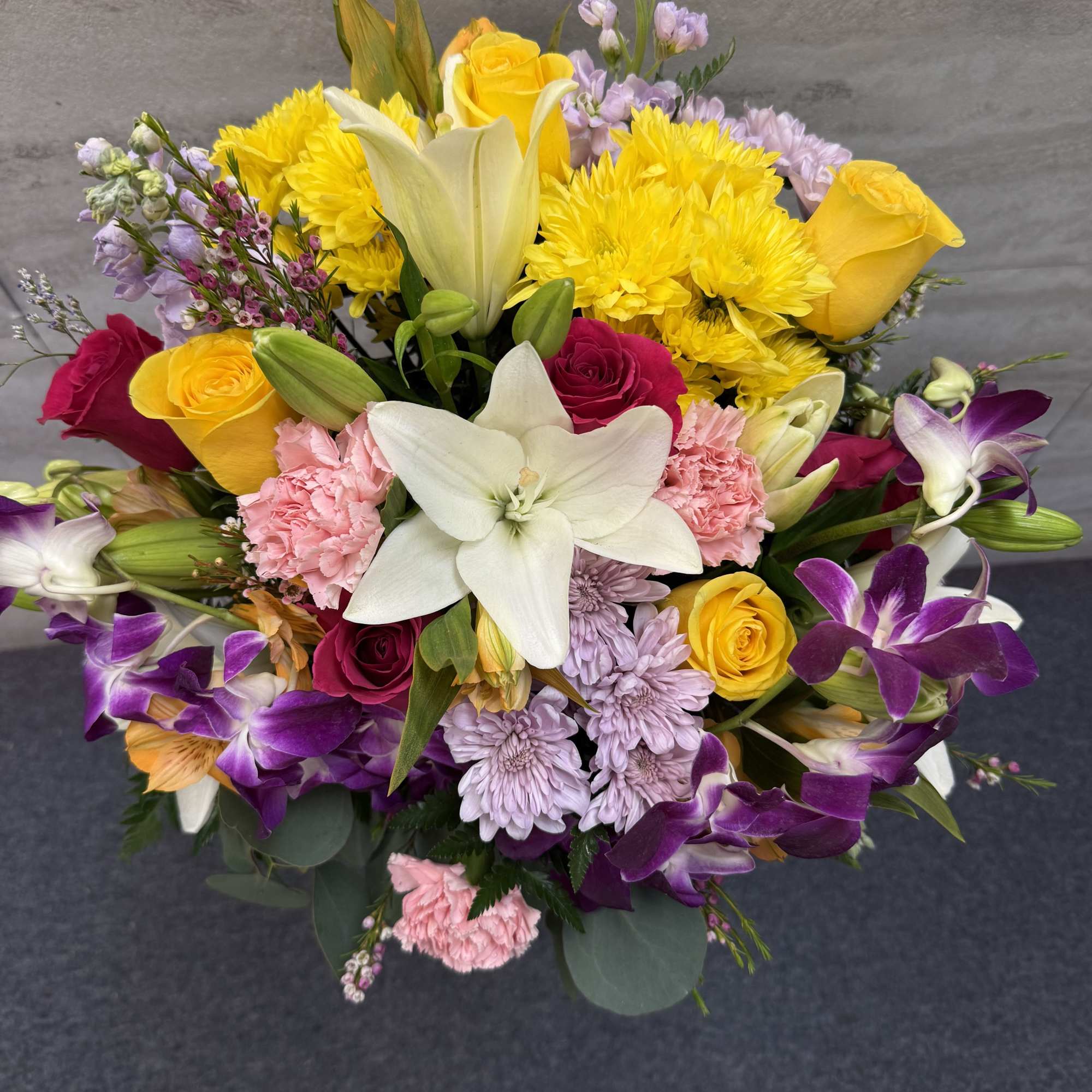 (ALL-ROUND) A vibrant, tropical-inspired bouquet featuring stunning dendros, elegant lilies, and soft, photo 2 of 2
