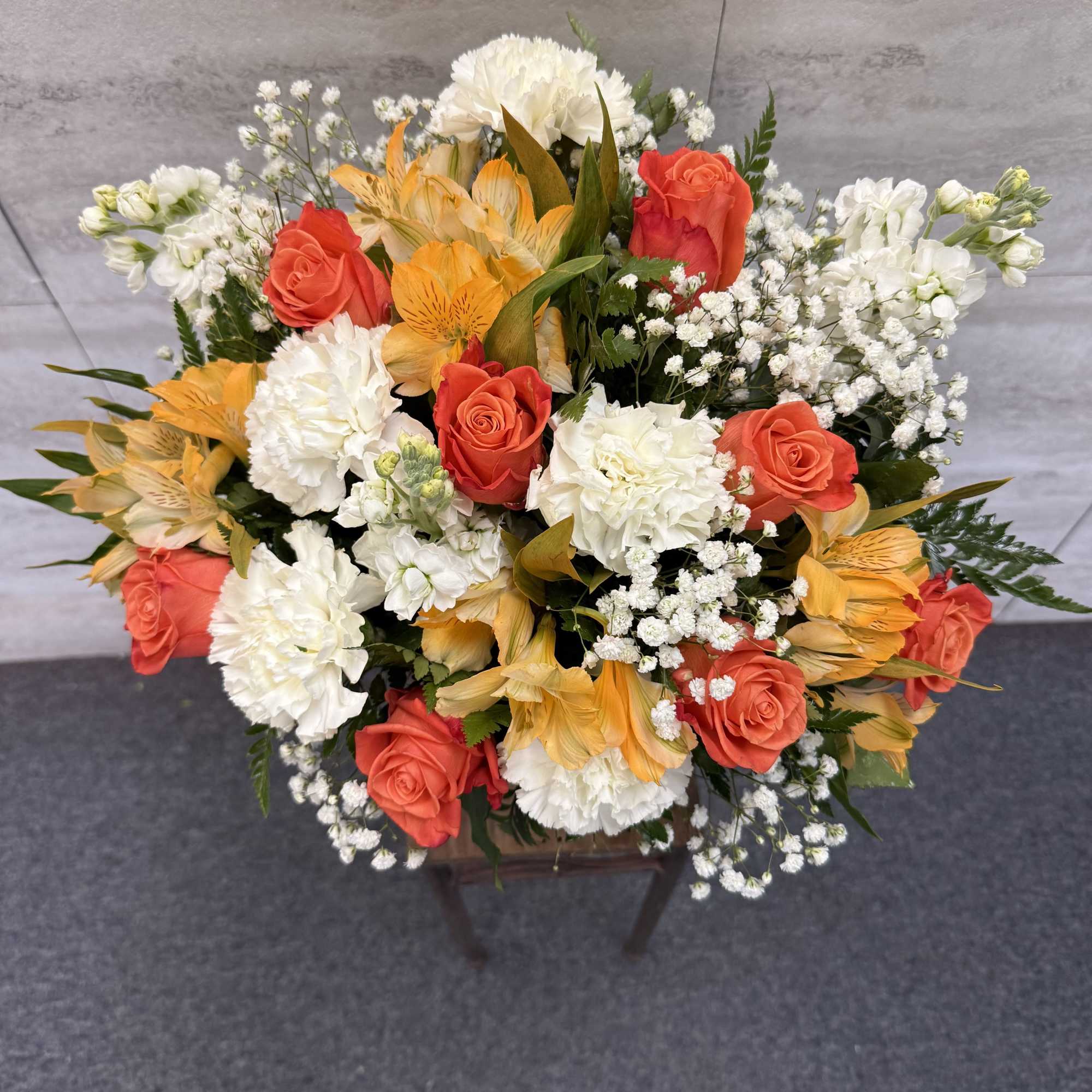 (ONE-SIDED) Orange roses accented with delicate white blooms for a bright, cheerful, photo 2 of 2