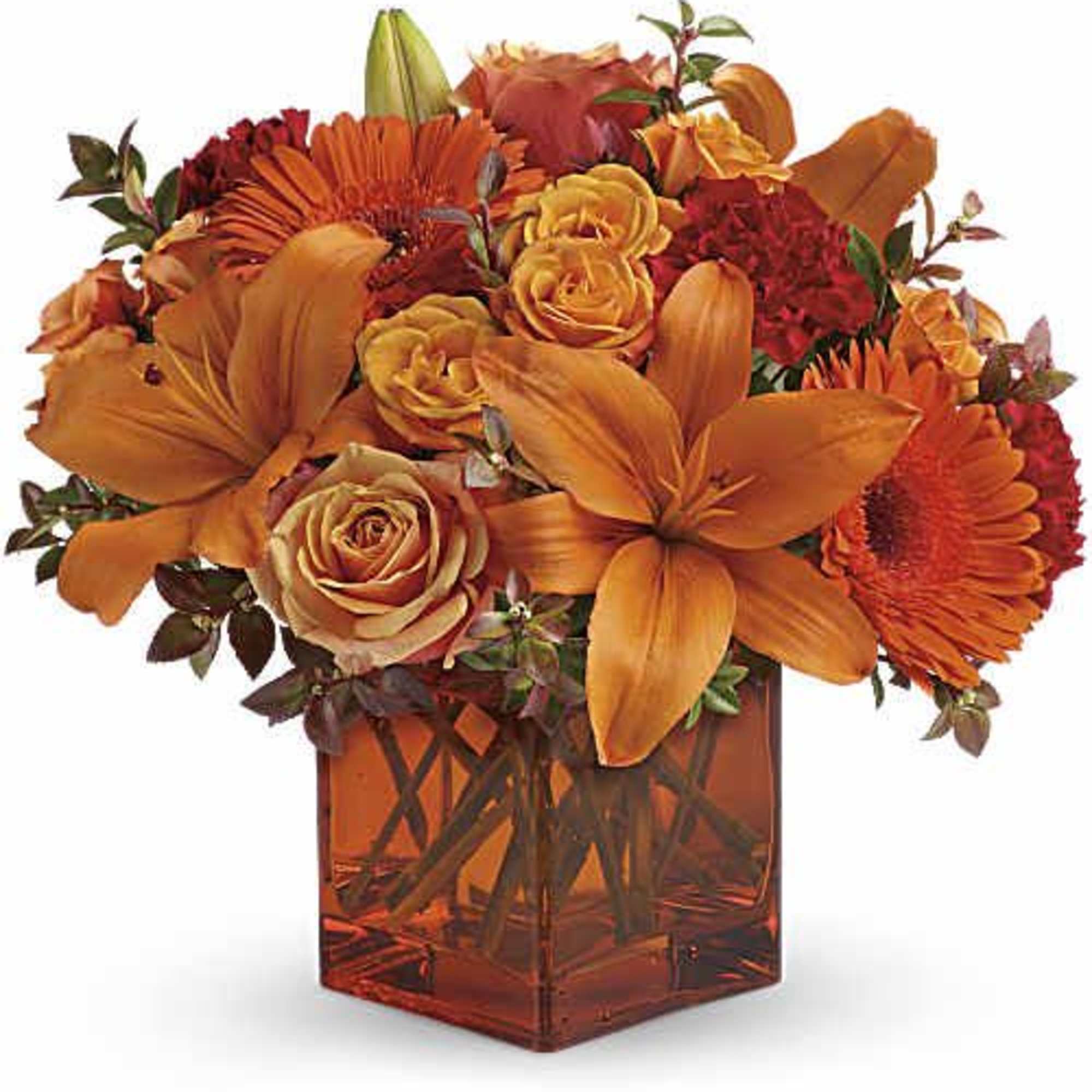 Orange and red flower arrangement in a square glass vase