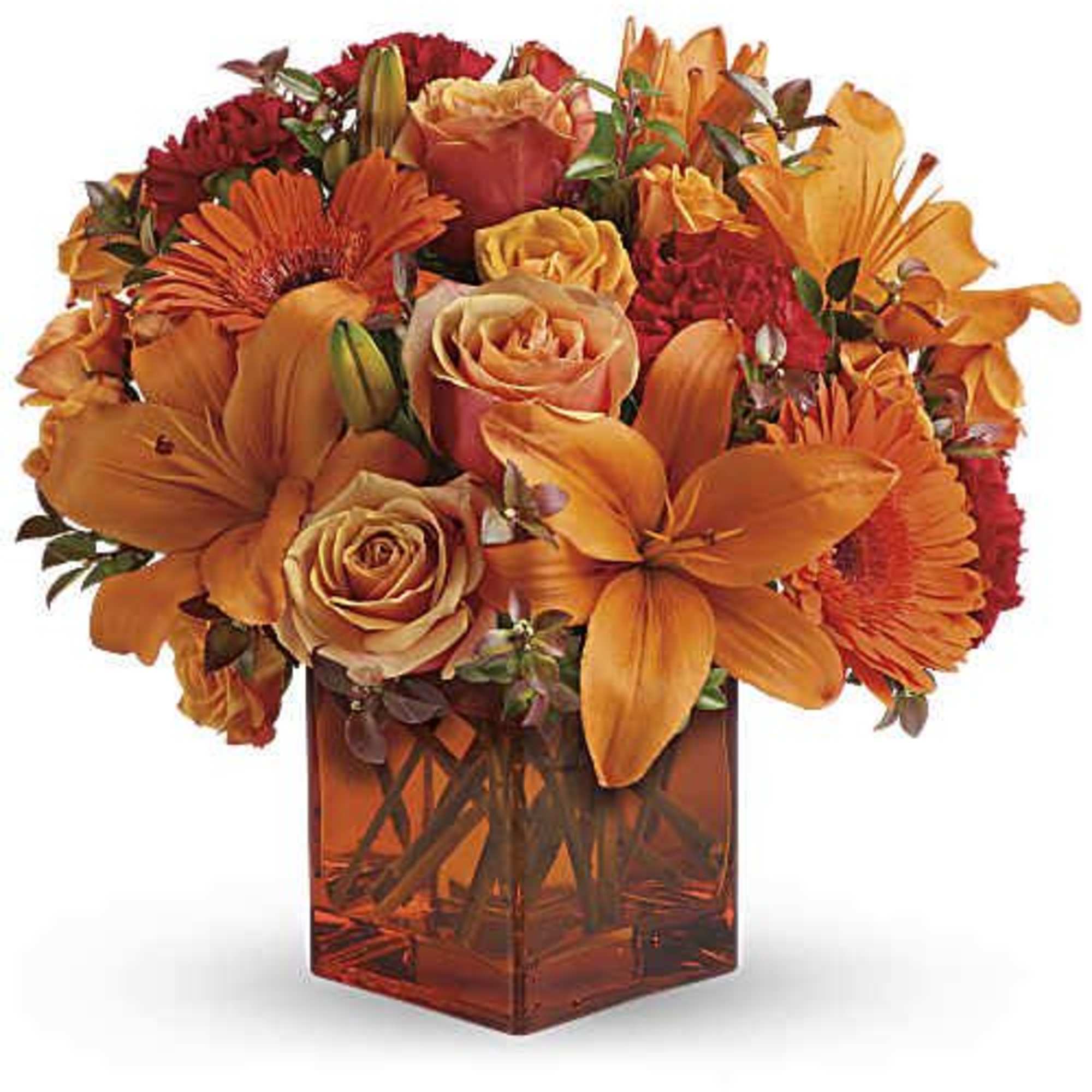 Orange and red mixed bouquet in a square glass vase