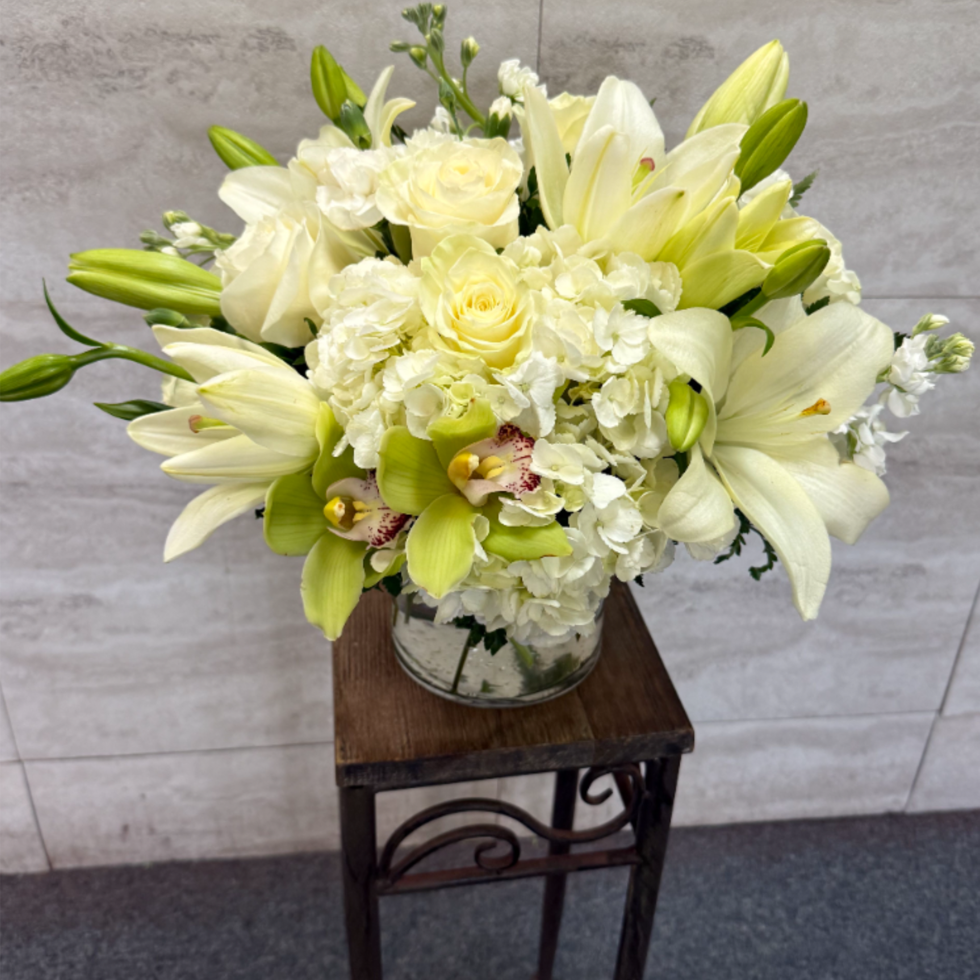 All-white arrangement of lilies, roses and orchids for a timeless, elegant touch-perfect