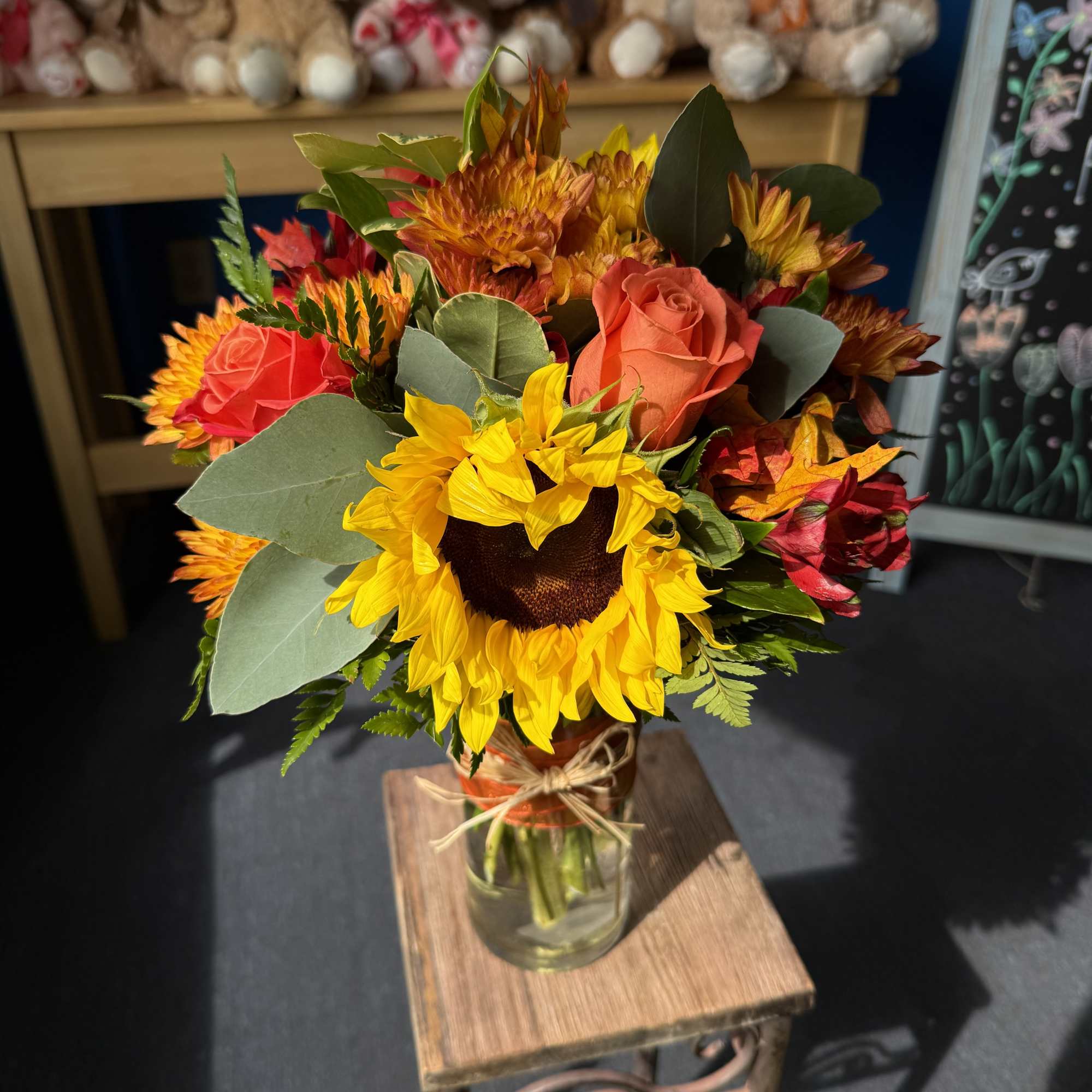 Sunflower and rose bouquet in a glass vase