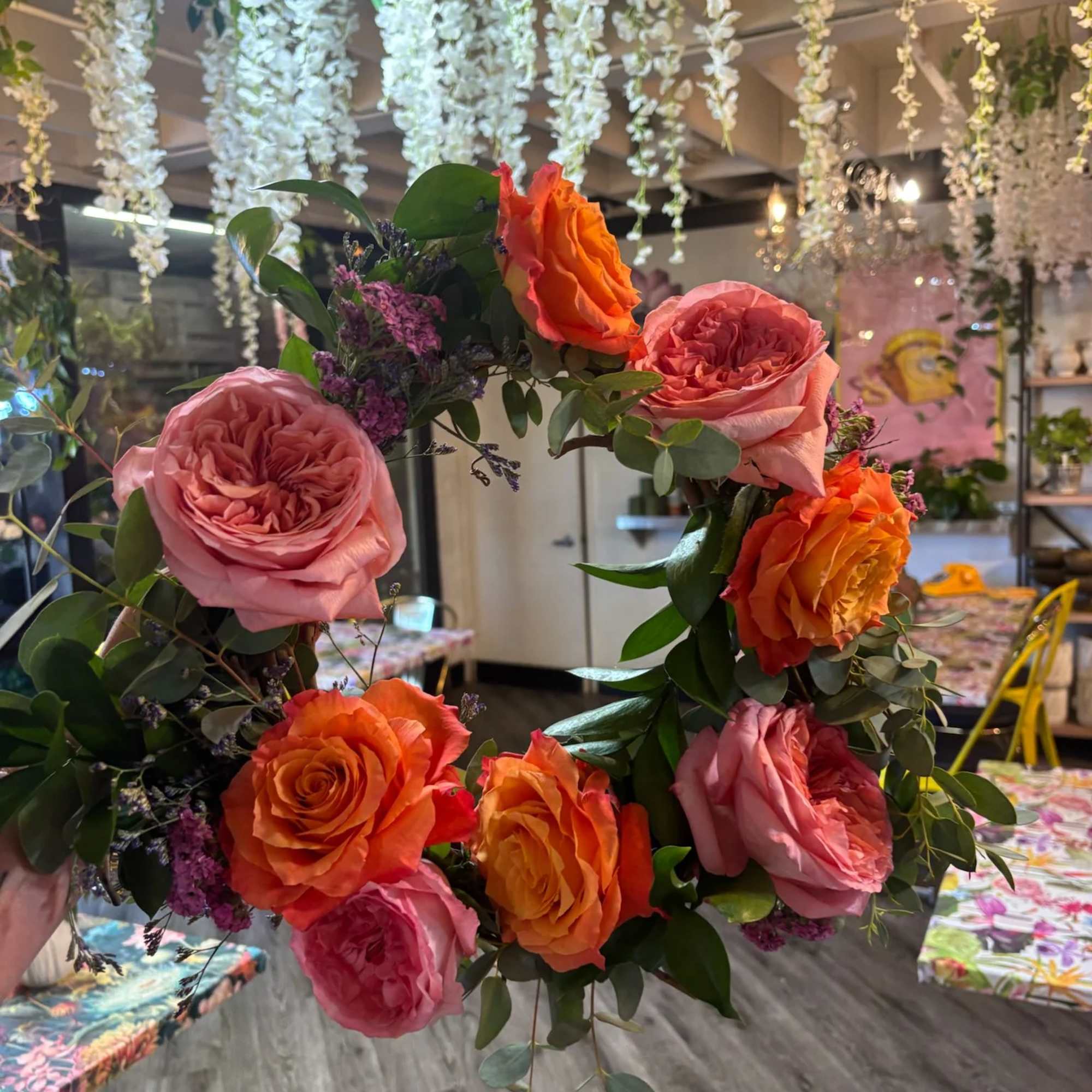 Floral wreath with pink and orange roses and greenery