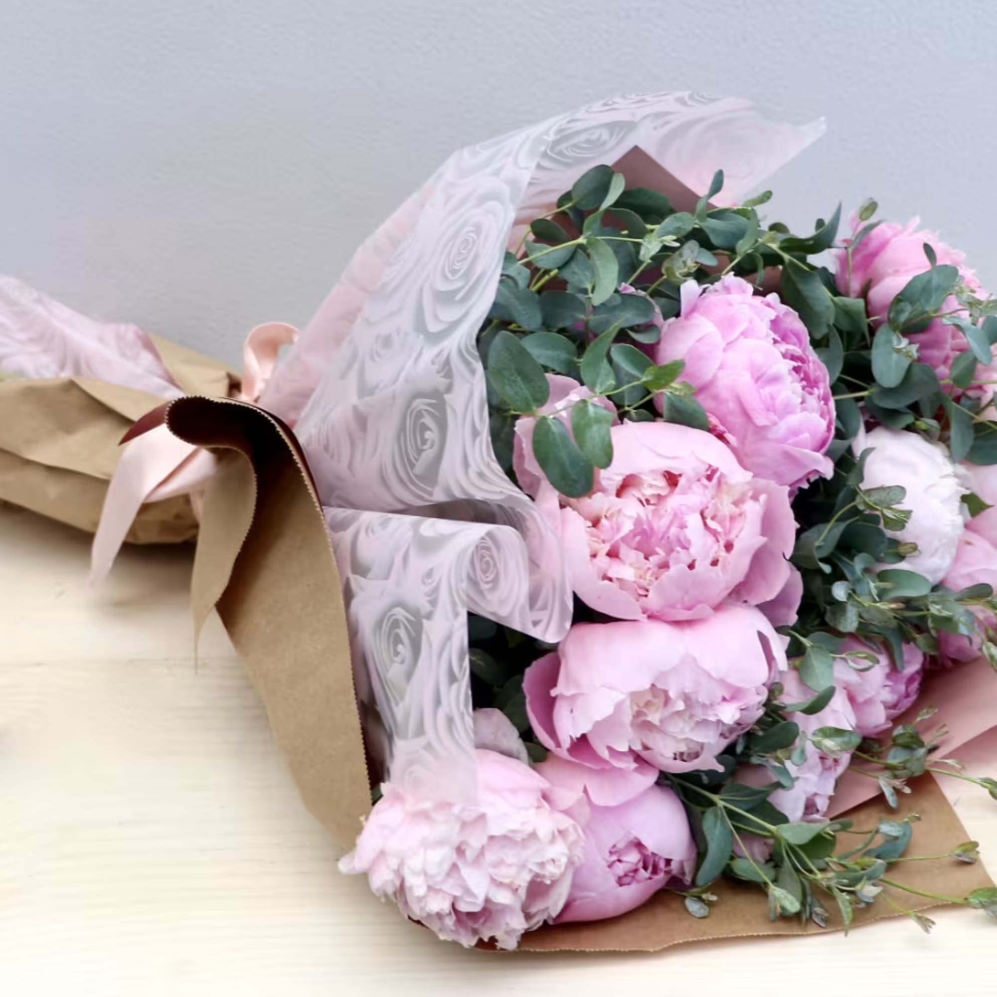 The standard size holds 6 peonies with seasonal greenery. The photo shown