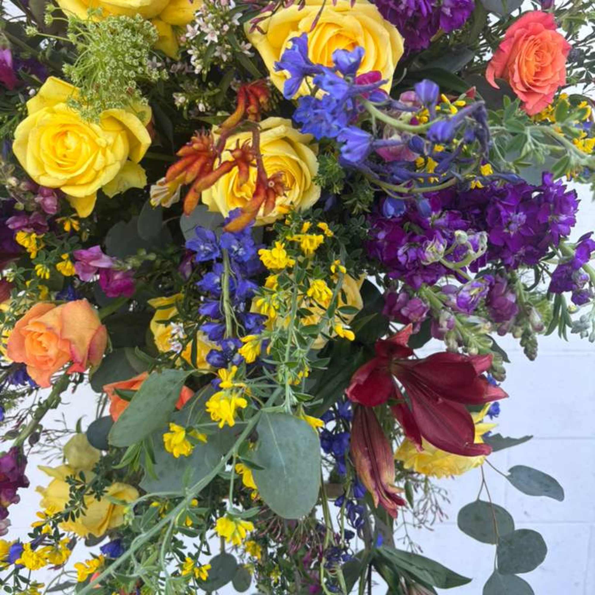 Mixed bouquet with yellow and orange roses and purple flowers