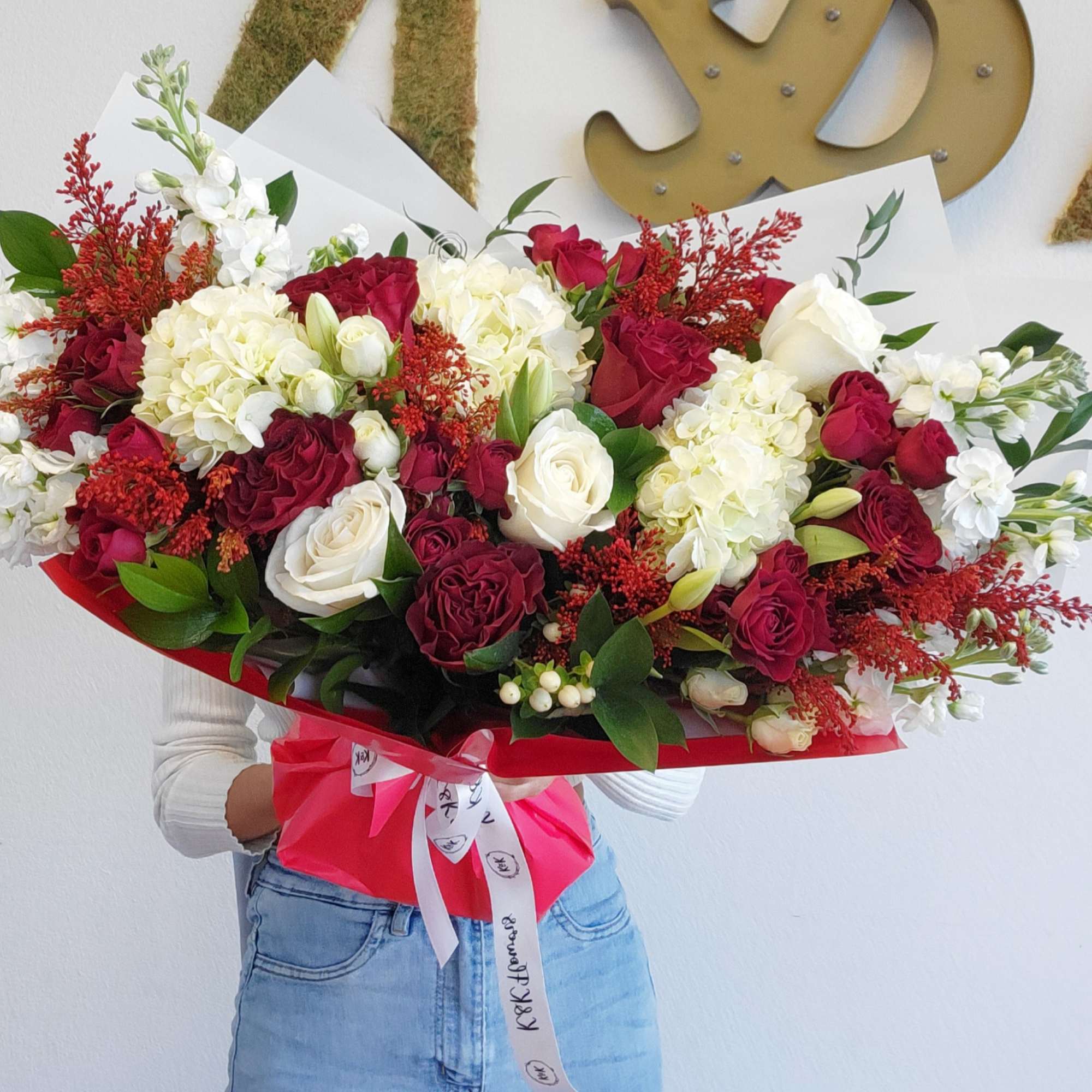 Large bouquet of red and white roses with hydrangeas and red filler flowers